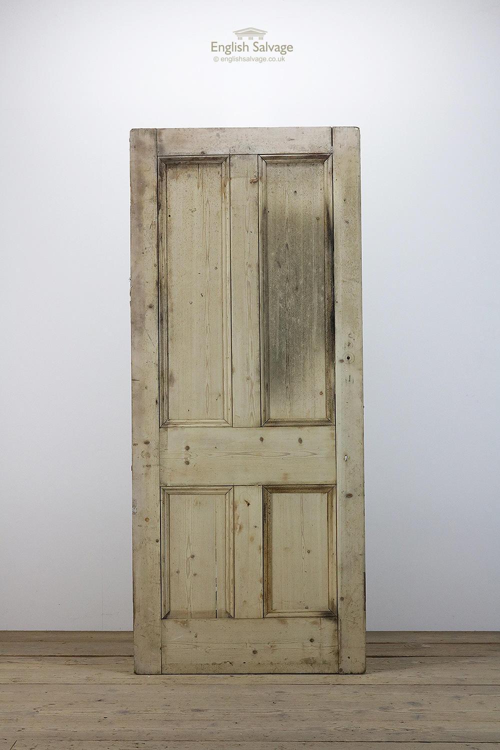 Reclaimed old Victorian pine door with four beaded panels. The door has rounded edges, lock, handle and nail holes, some separation to the top and a split to one of the lower panels.