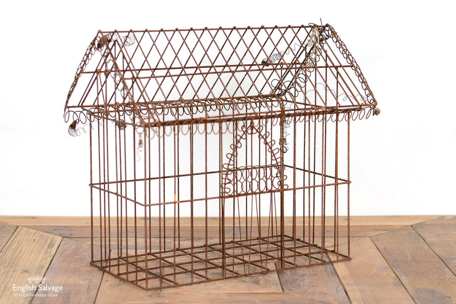 Old Victorian wirework house with an opening roof. Decorative door and roof edging. Would look great with plants planted inside it. 

Some loose wirework throughout, commensurate with age but main structure is sound.