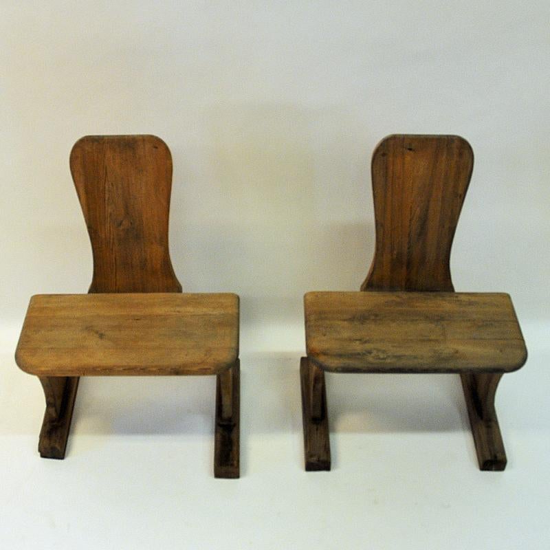 Solid, rough, old and beautiful! Wood bench pair from the 1930s school days in Sweden. High back and wide seat. Lovely as a pair of extra chairs, or just for decoration with a couple of plants or ceramics on etc. Perfect natural patina and good