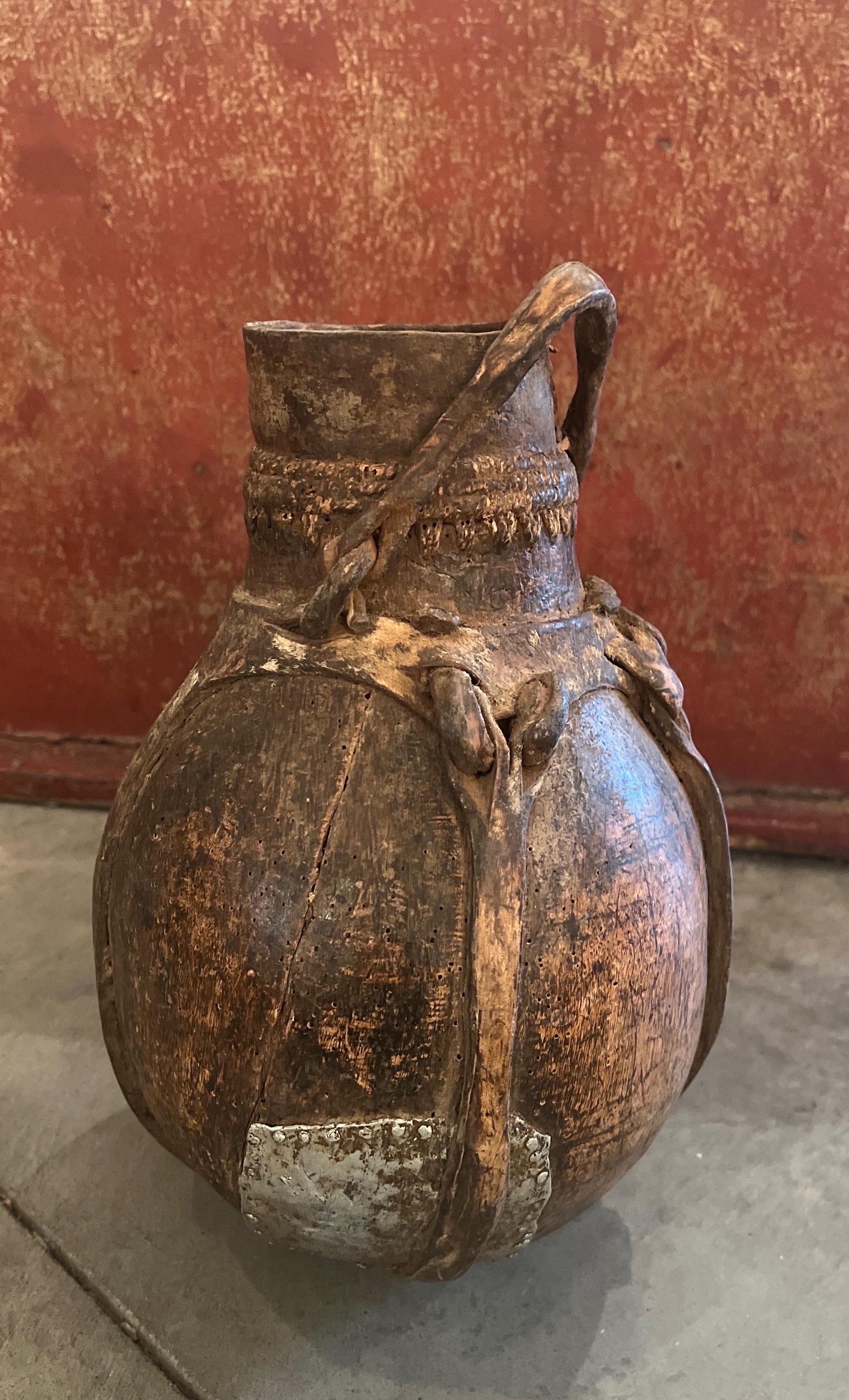 Old Weathered  Wood And Leather Container With Metal Repair From Africa In Good Condition For Sale In New York, NY