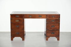 Old wooden English desk from the early 20th century with brass elements