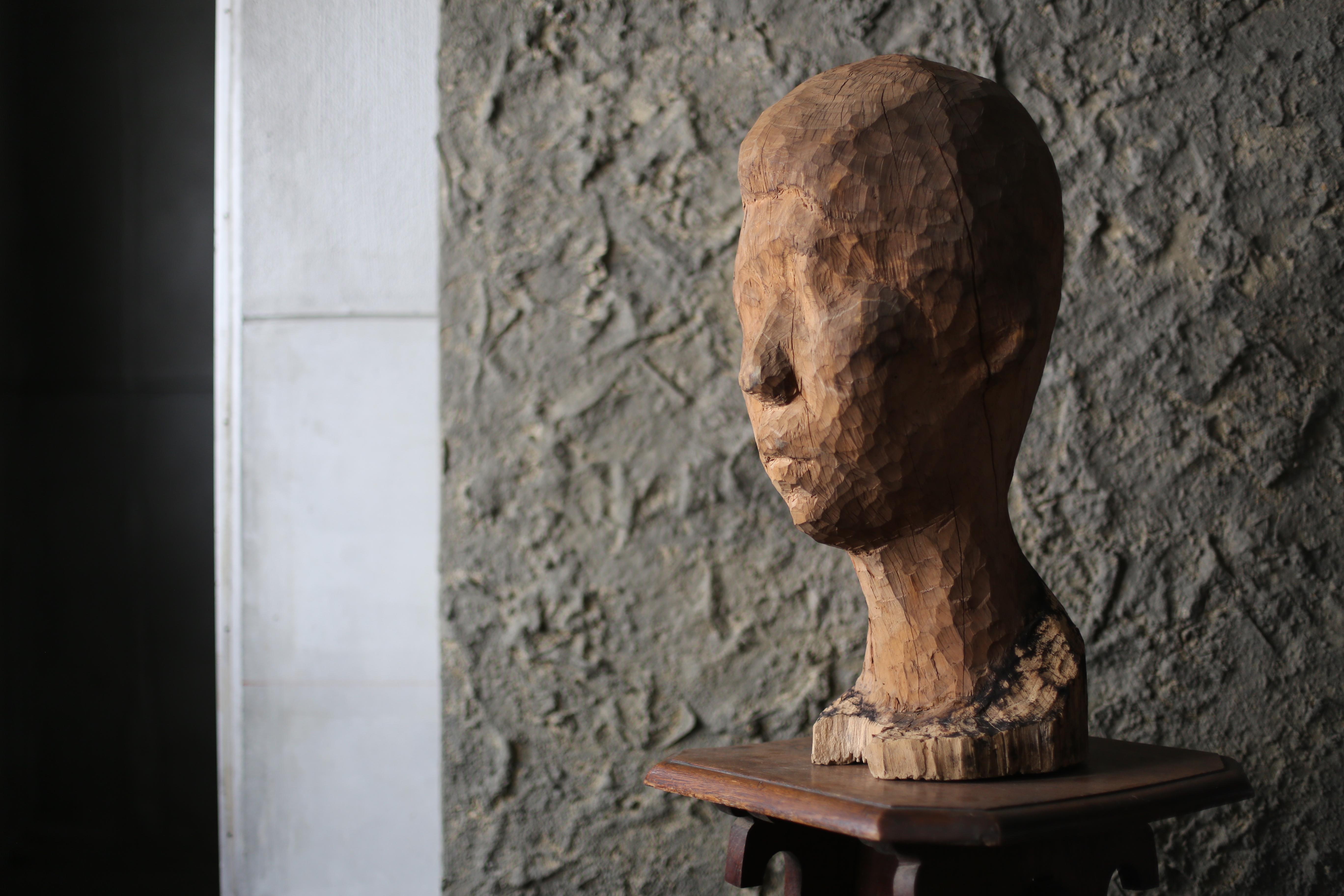 This is a very old wooden carving of a face.

Details are unknown, but it was discovered in Japan.

This piece may be in the works of an unknown artist.

It may be in the works of a famous artist.

It may be complete.

All details are unknown, but