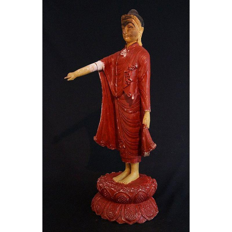 Material: wood
Measure: 80 cm high 
Weight: 6.5 kgs
Mandalay style
Originating from Burma
Early 20th century
Made as the original on top of Mandalay Hill in Burma. The Buddha is pointing down towards the place where the city Mandalay should be