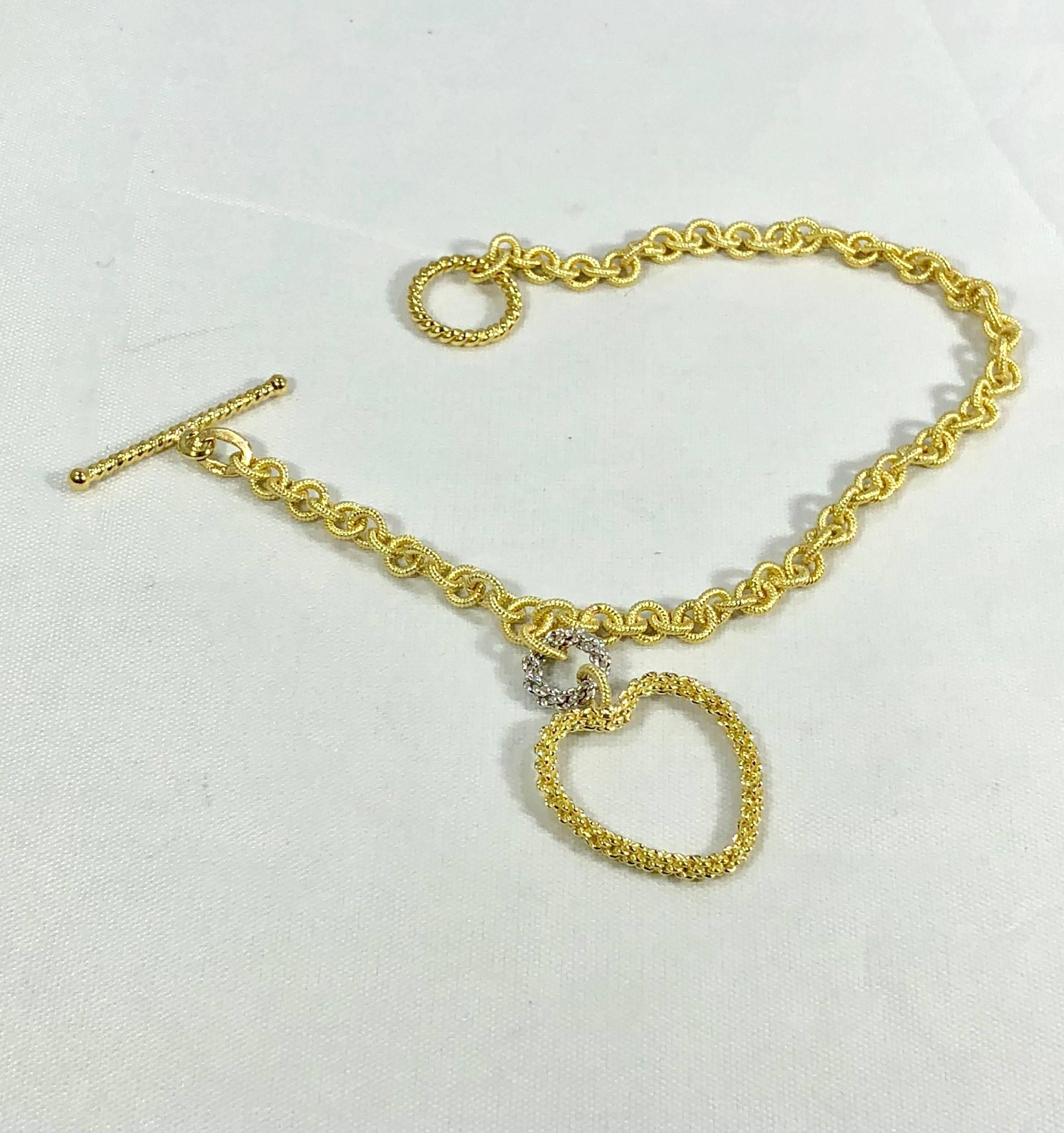 Old World Chain 18 karat two tone white and yellow  gold fancy anchor link bracelet. This is a unique bracelet designed by Old World Chain, measuring 7 5/8 inch length, 4mm wide approx..There is an 18 karat yellow gold woven open heart measuring