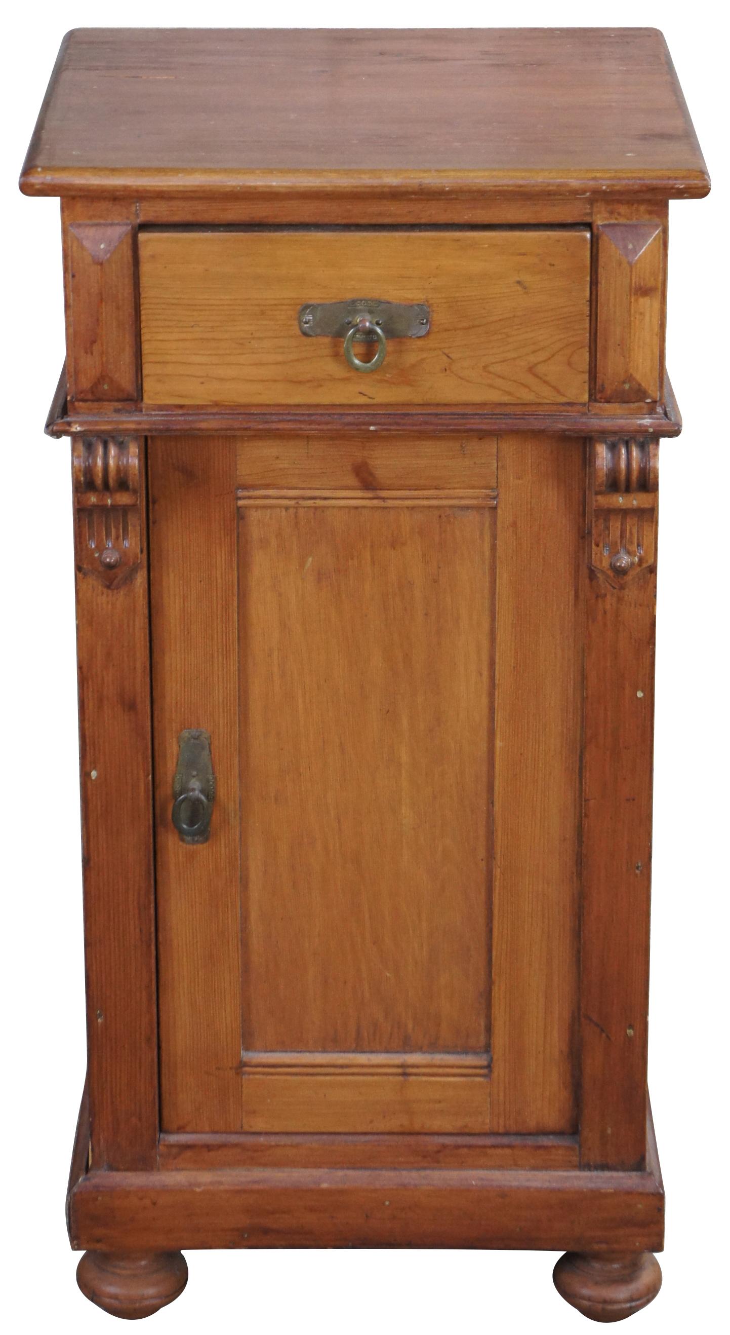 Late 20th century English pine cabinet. Features a square shaped case with upper dovetailed drawer, lower cabinet, scrolled corbels and bun feet. Measure: 32