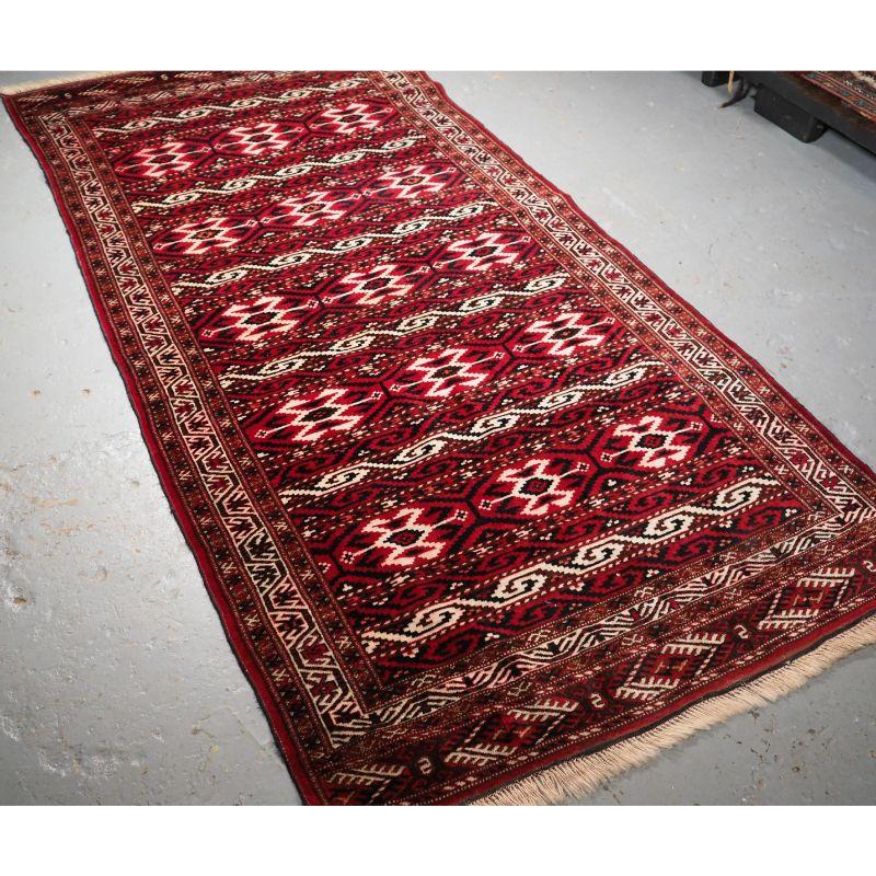 Alter turkmenischer Yomut-Langteppich mit Streifenmuster.

Der Teppich ist gut gezeichnet mit Bändern unterschiedlichen Designs, die Bordüre ist typisch für Yomut-Teppiche.

Der Teppich ist in gutem Zustand mit gleichmäßiger Abnutzung und
