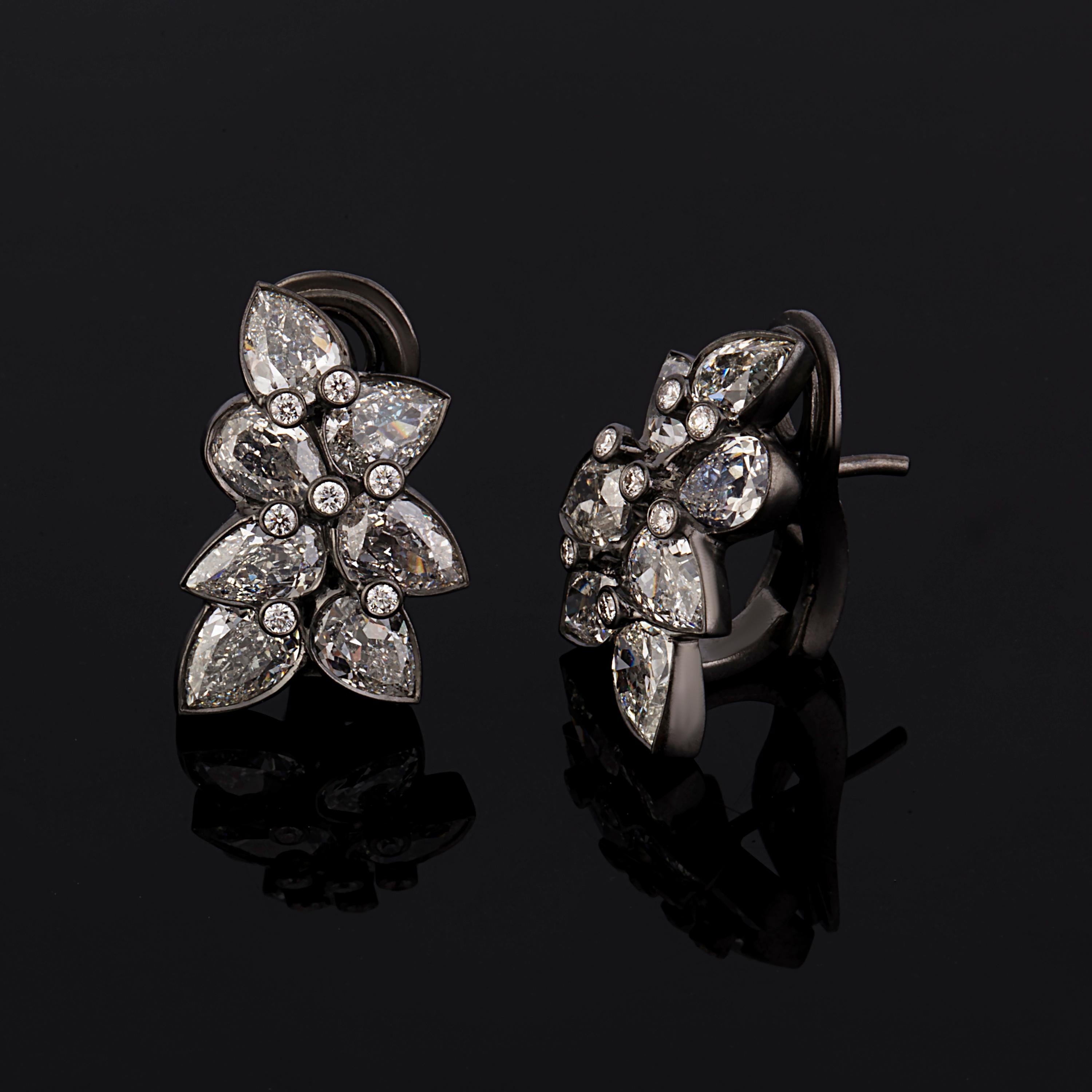 This Beautiful Floral / Leaf Cluster Earring is Nature Inspired.
It has 4.49 Carat Old Cut Pear Diamonds G/H Color Si quality , 0.42 Carat Round Brilliant Diamonds G/H color VS Quality and 7.49 grams 18 Karat Blackened Gold. 
This Earring is Hand