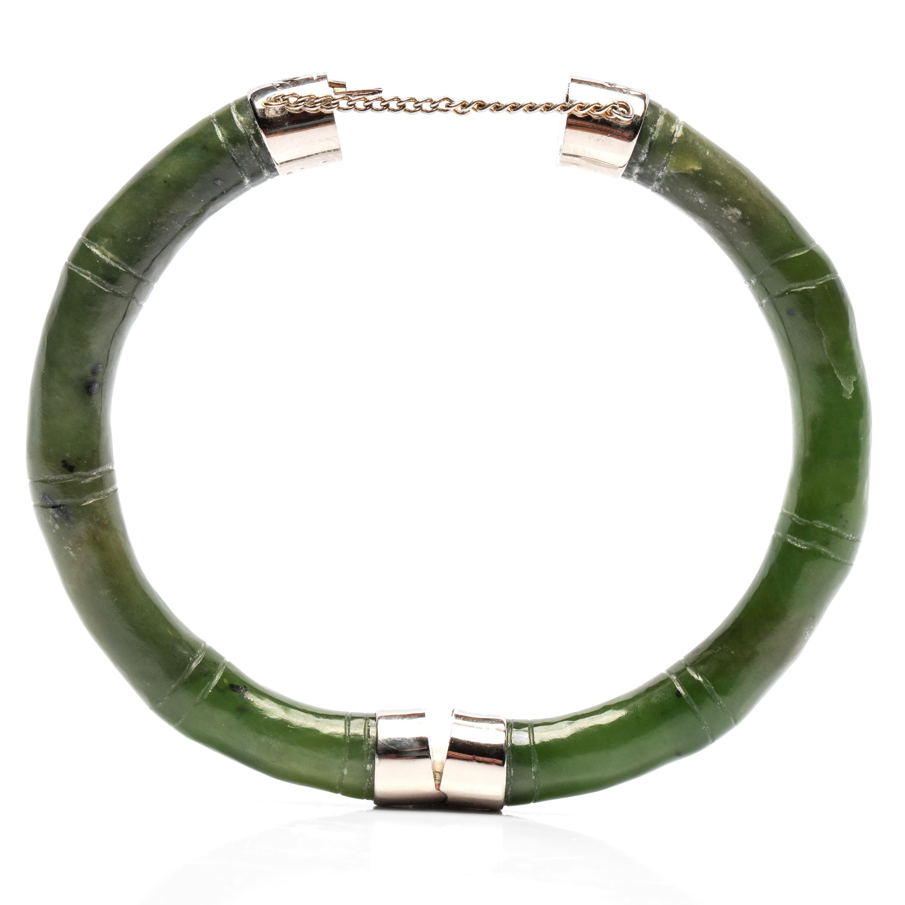 The polish of this bangle helps us to date it to the 1940s. The industrial revolution didn't reach China to the point of widespread saturation until the 1950s. Jade that was carved and polished prior to electricity and modern polishing equipment