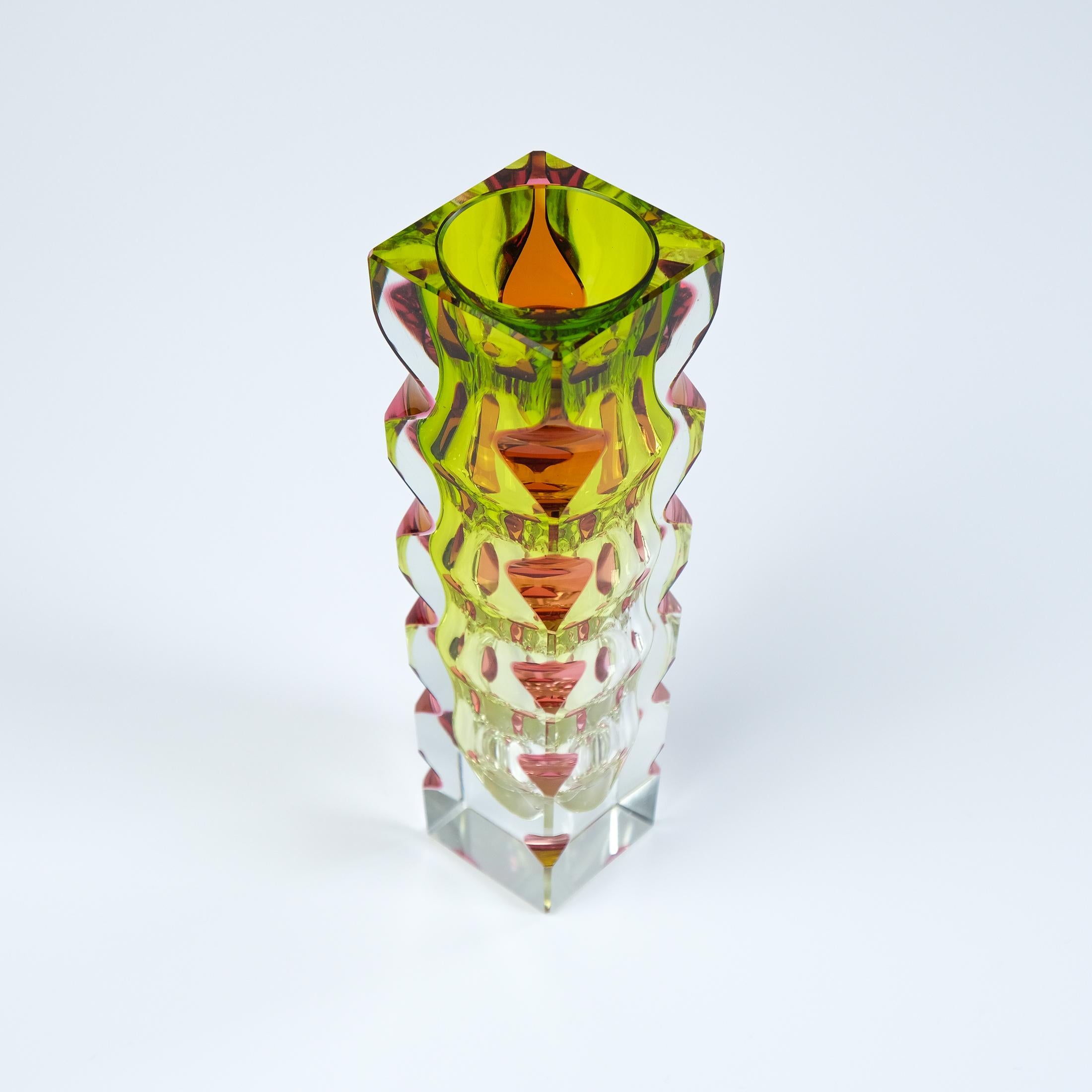 For sale is a Mid-Century Bohemian three-colour cased, cut and polished vase designed by renowned Czech glass artist, Oldrich Lipsky in c.1964 for the Novy Bor (EXBOR) glass foundry. 

The vase, which is made of pink, green and clear glass, creates