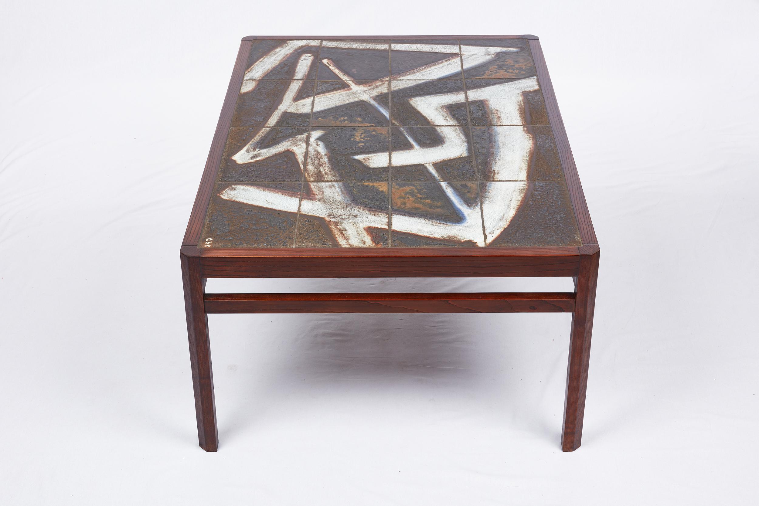 Ole Bjorn Kruger tile coffee table. Fabulous abstract artwork. Dark stained oak legs and frame. We can trim the legs if they are too tall.