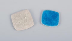 Ole Bjørn Krüger. Eight brooches in glazed stoneware in blue and white shades