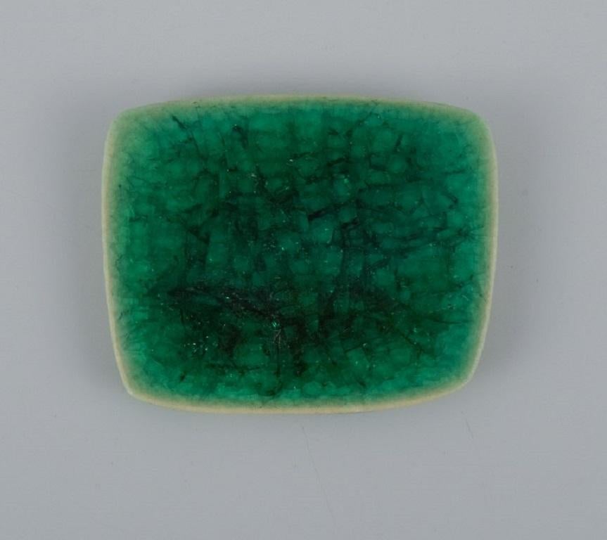 Modernist Ole Bjørn Krüger, Eight unique brooches in glazed stoneware in shades of green For Sale