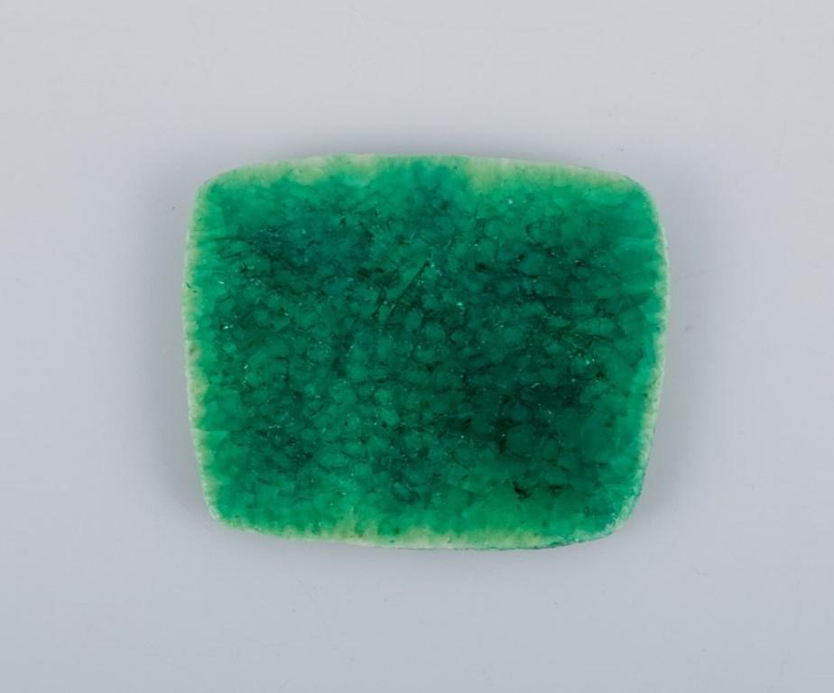 Women's Ole Bjørn Krüger. Seven brooches in glazed stoneware in blue and green shades. For Sale