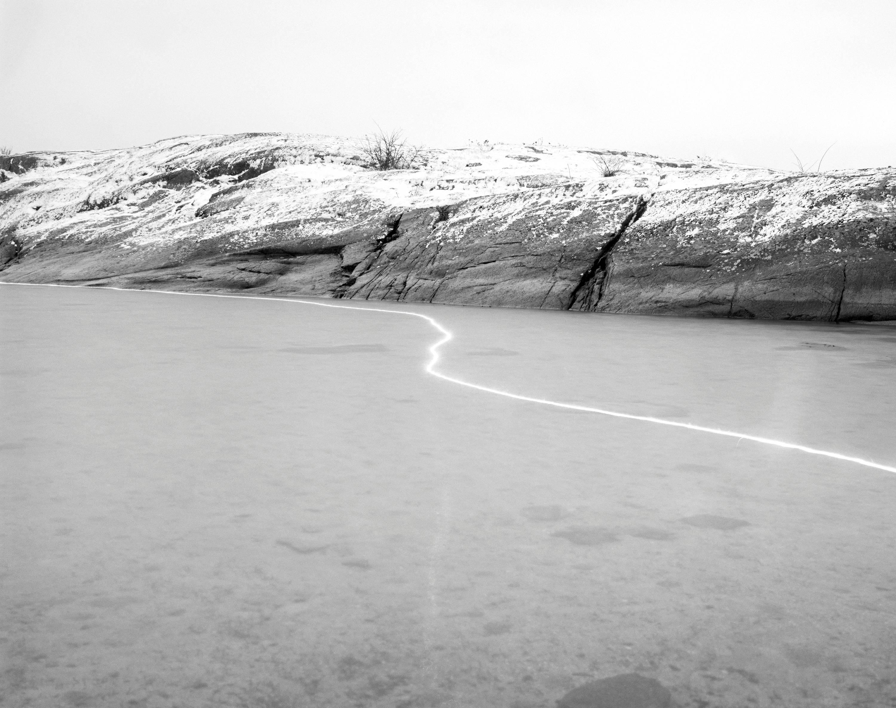 Ole Brodersen Landscape Photograph - Wood and Sparkler 02 - black and white Scandinavian landscape photo with water