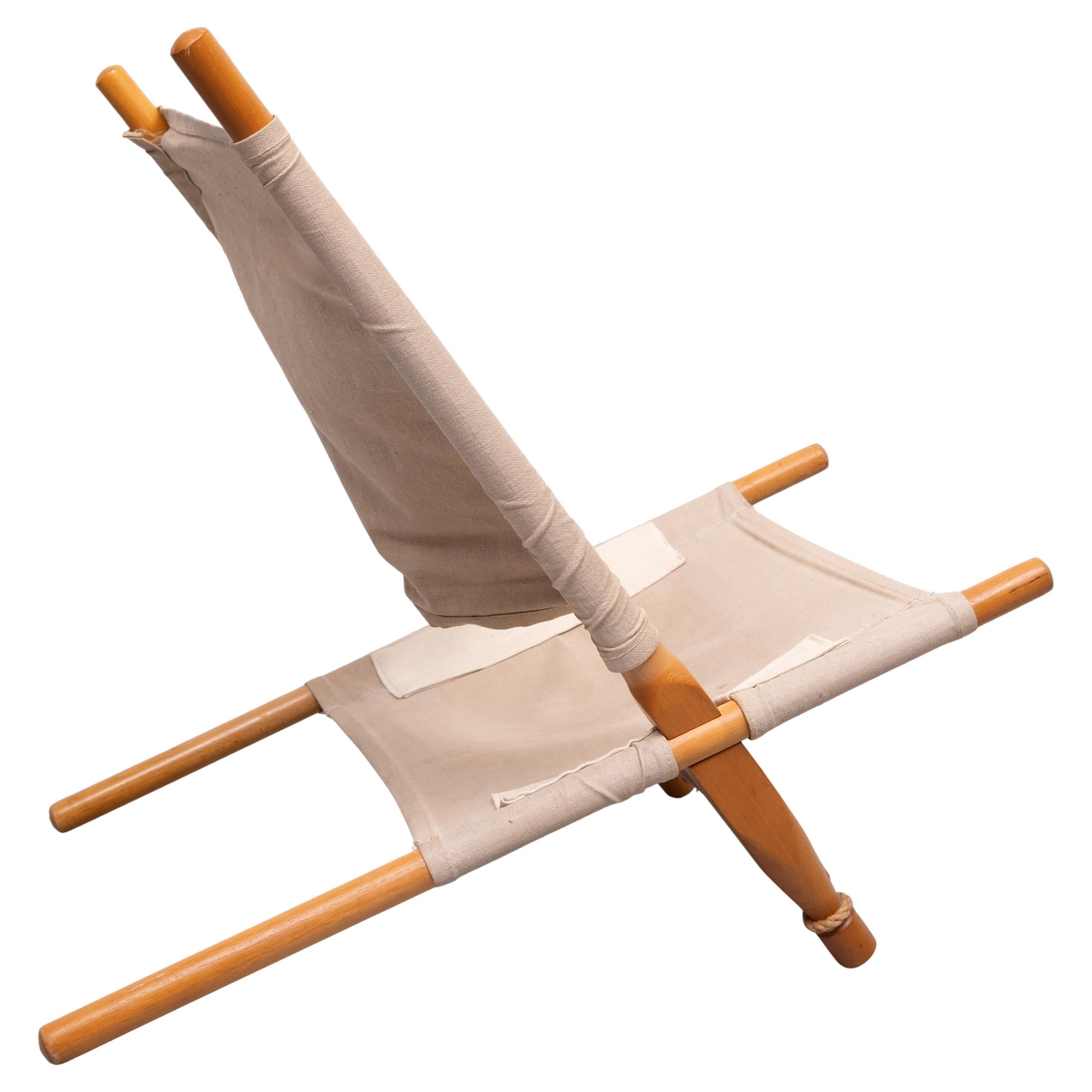 Saw chair designed by Ole Gjerløv-Knudsen. 1958 Denmark. Birch wooden frame. Four parts sliding in each other. The seating angle can be changed by adjusting the parts more forward or afterwards. Original canvas seat. Comes with repairs .Rope to keep