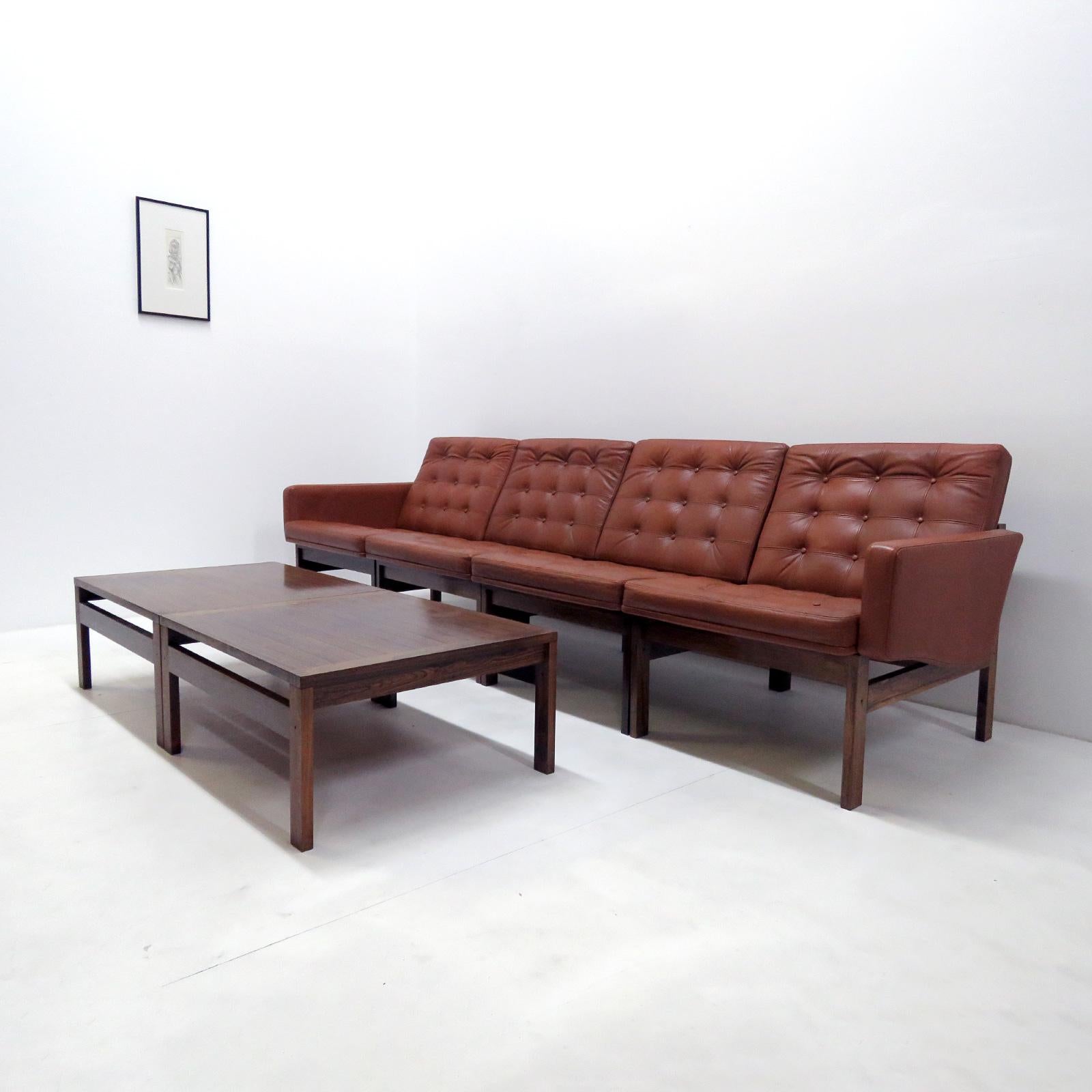 Moduline sofa set designed by Ole Gjerlov Knudsen & Torben Lind, manufactured by France & Son, Denmark 1962. This modular set contains four seating elements, (two of which with one arm each) and two low solid rosewood side tables. The sofa has a