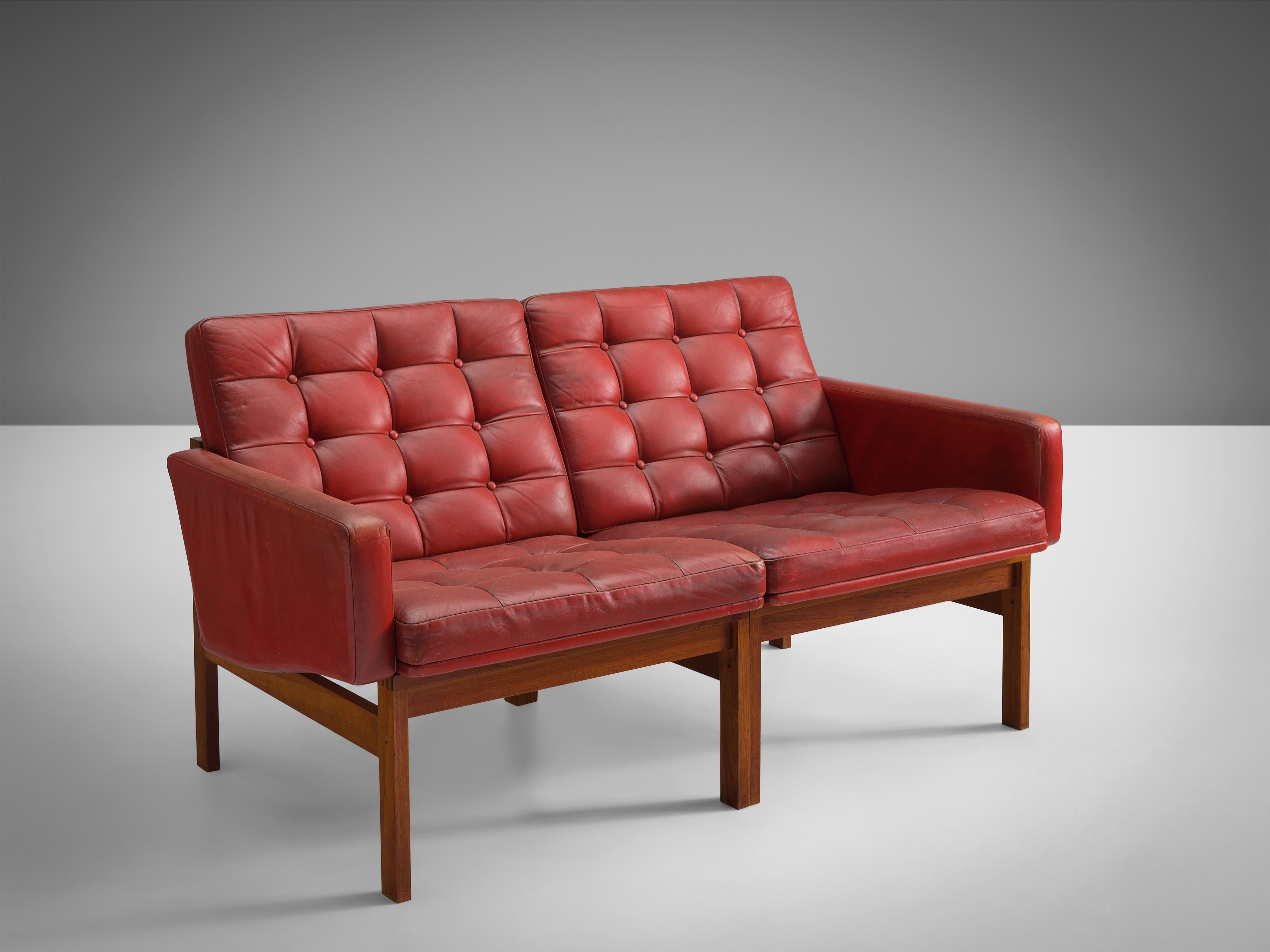 Ole Gjerløv-Knudsen & Torben Lind for France & Søn, two seater sofa, teak, leather, Denmark, 1962 

Modern and beautiful constructed sofa based on a tight and simple design. The teak frame holds a red leather body with buttoned cushions in patinated