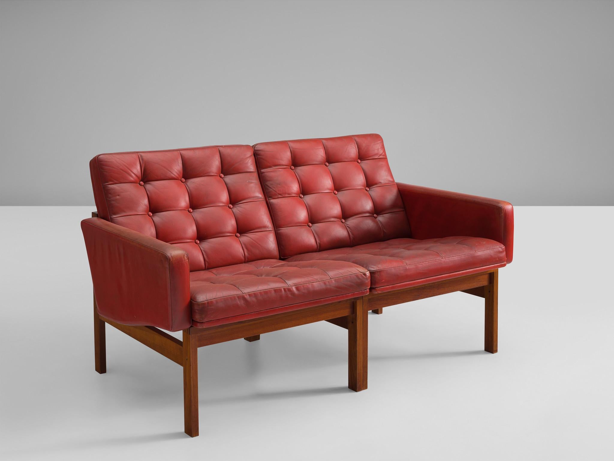 Ole Gjerløv-Knudsen & Torben Lind for France & Søn, two seater sofa, teak, leather, Denmark, 1962 

Modern and beautiful constructed sofa based on a tight and simple design. The teak frame holds a red leather body with buttoned cushions in patinated