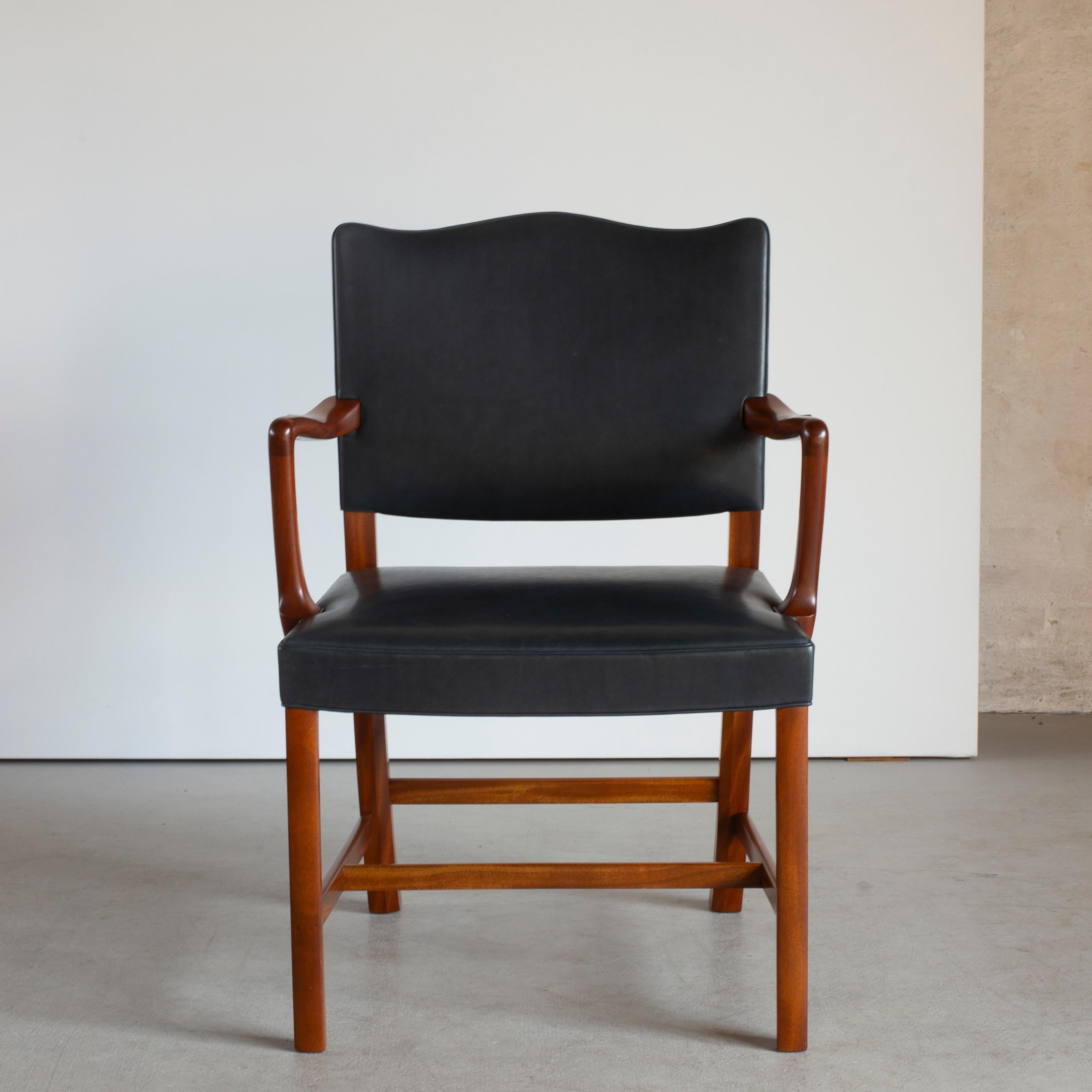 Ole Wanscher armchair in mahogany and black ox-hide. Executed by A. J. Iversen, Copenhagen, Denmark.
