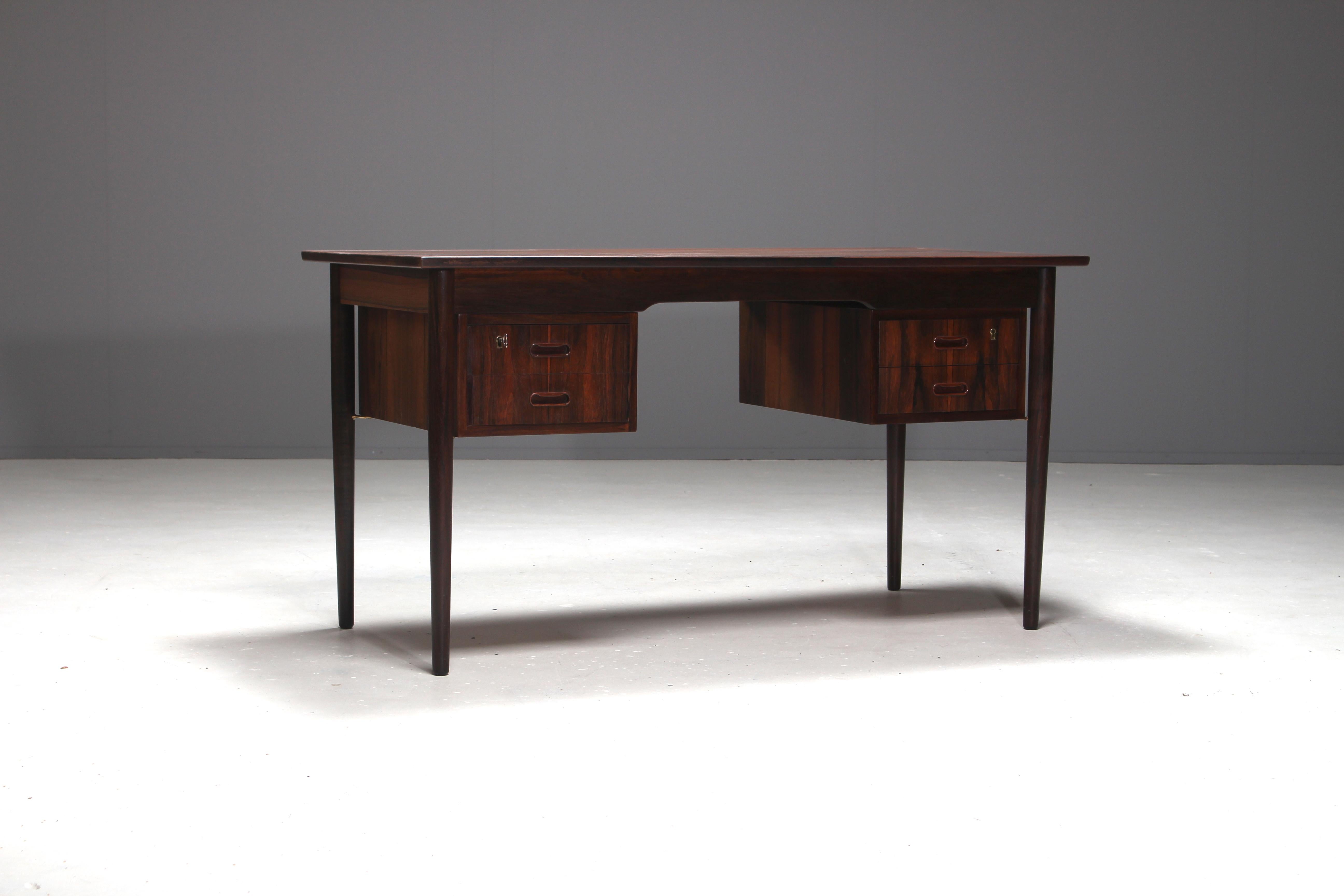 Exceptional beautiful rosewood desk attributed to Danish furniture designer Ole Wanscher. He was one of the leading figures in the Scandinavian Design movement.
The desk is made out of the most beautiful Brazilian rosewood and is a true example of