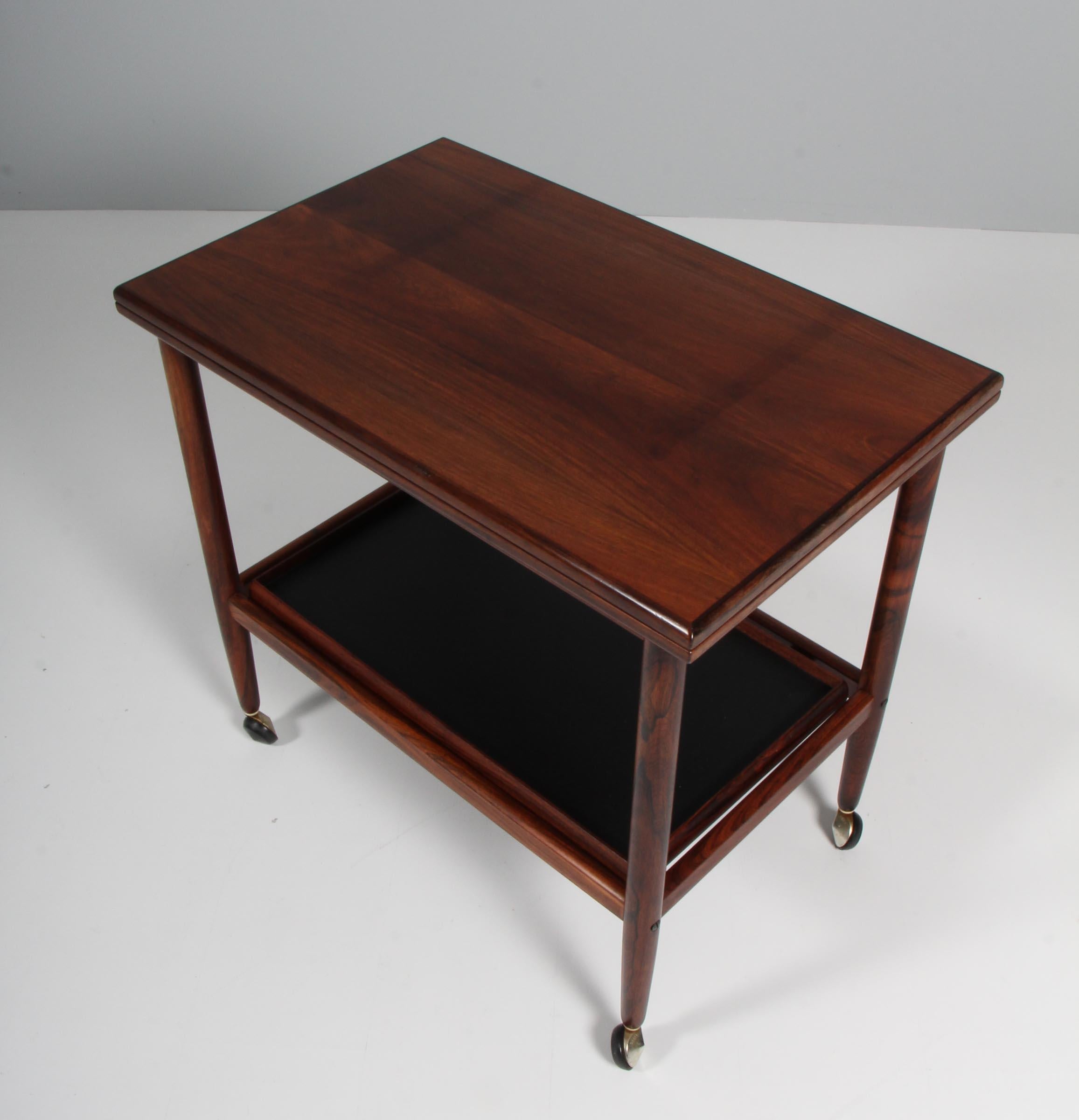 Ole Wanscher bar cart / tray cart with frame of rosewood. Foldable top with a width of 44/88 cm. 

Buttom tray of black leather.

Model Rungstedlund, made by Poul Jeppesen.

