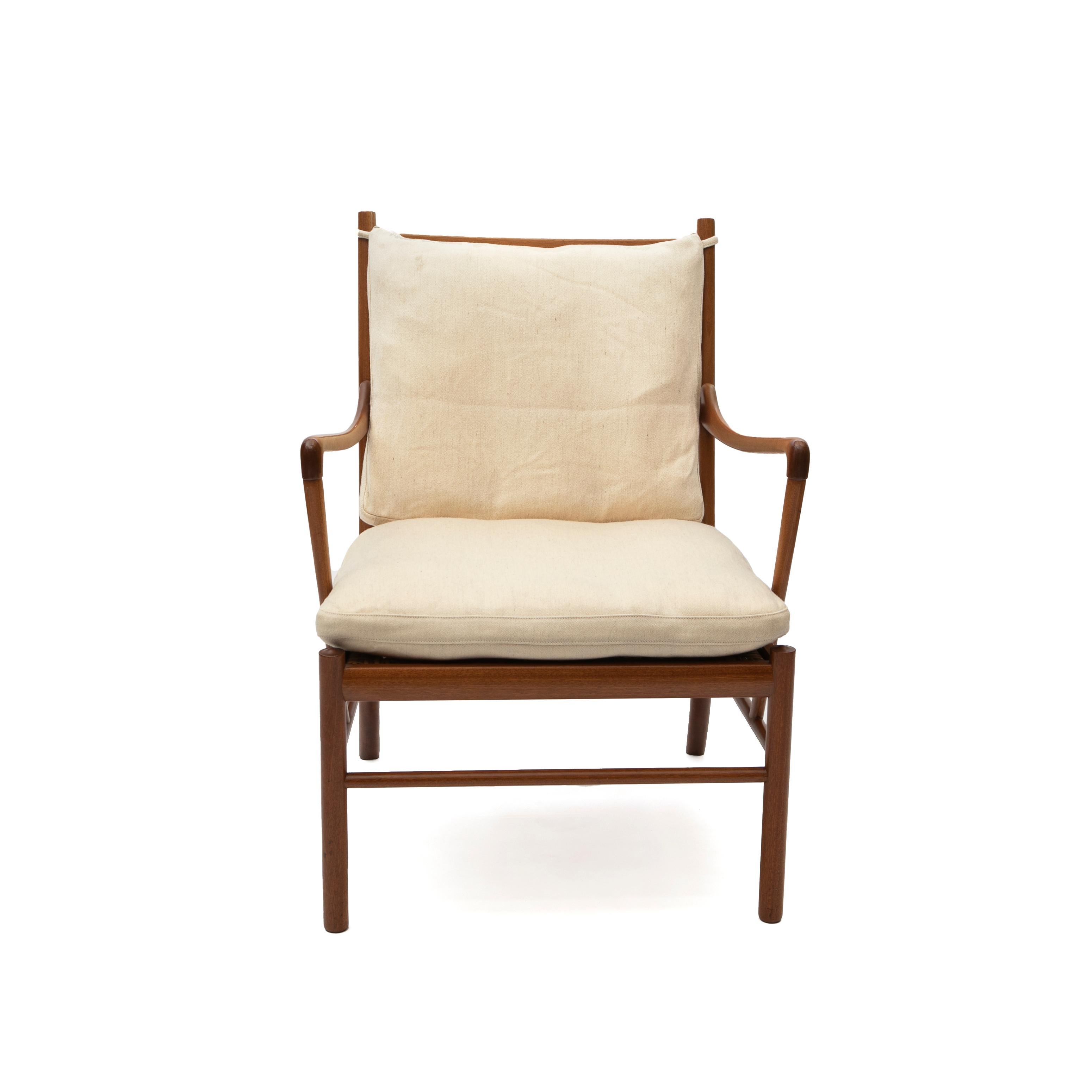 Ole Wanscher 1903-1985.
Ole Wanscher's Colonial Chair and ottoman in solid mahogany.
Woven rattan cane seat and cushions covered in light Greenland wool.

Produced by Poul Jeppesen in Denmark circa 1980.

In good original and untouched