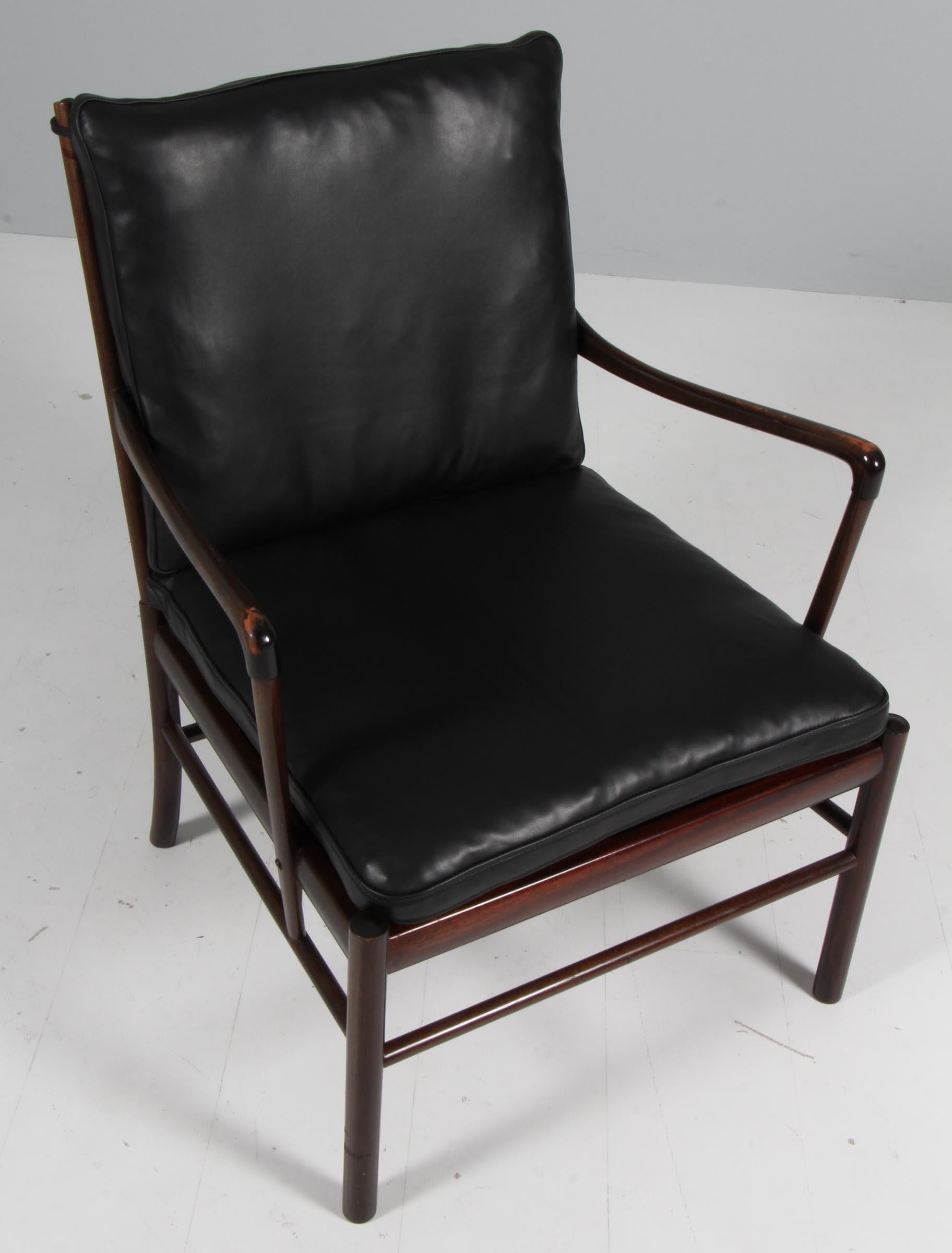 Ole Wanscher lounge chair new upholstered with black aniline leather.

Made in laquered mahogany. 

Model colonial chair, made by Poul Jeppesen.
