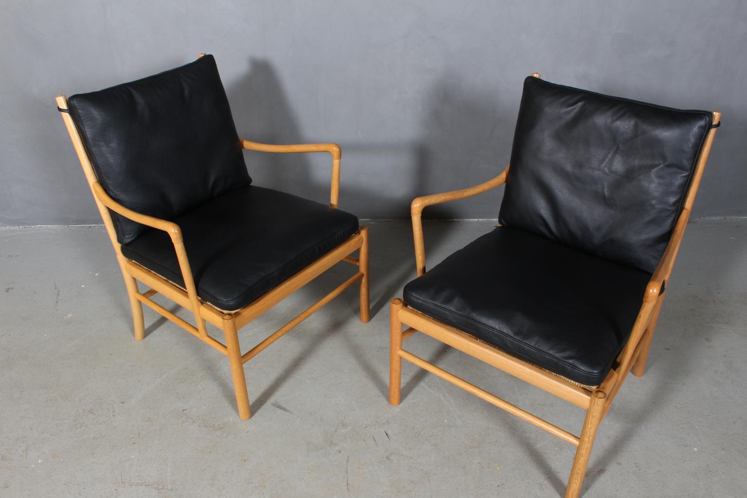 Ole Wanscher lounge chairs new upholstered with black pure aniline leather.

Made in oak.

Model OW149 colonial chair, made by Carl Hansen & Søn.