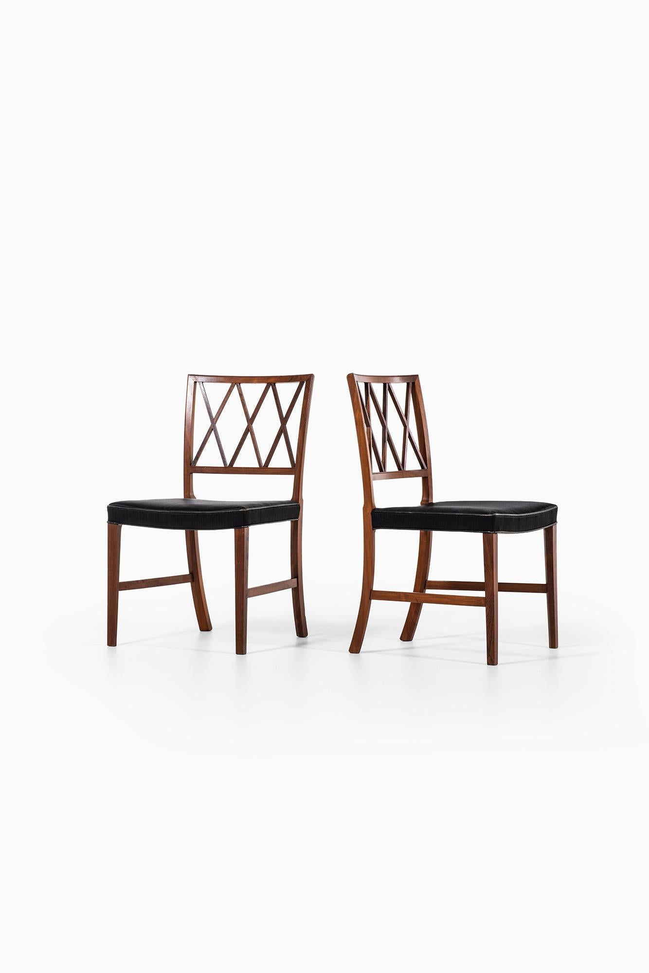 Rare set of 12 dining chairs designed by Ole Wanscher. Produced by cabinetmaker A.J Iversen in Denmark. Rosewood and original horsehair with black leather piping.