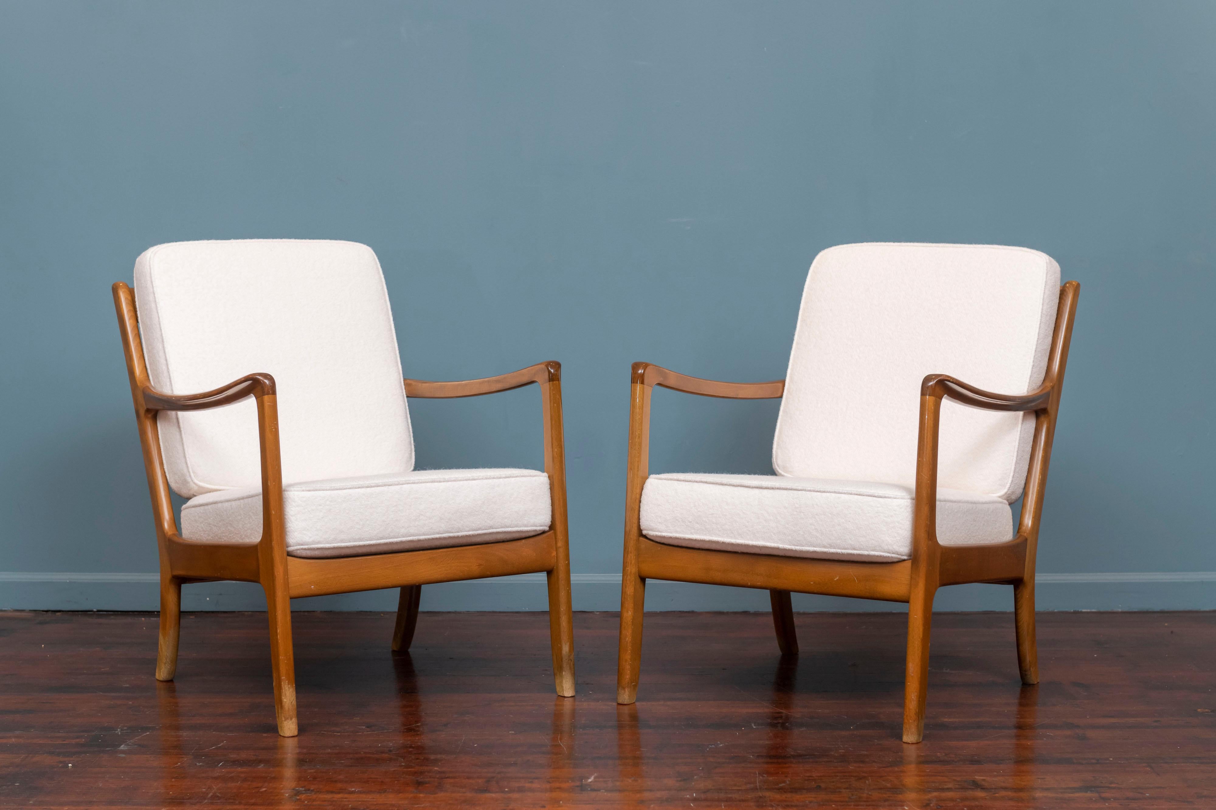Ole Wanscher design lounge chairs for France and Daverkosen, Denmark. 
Newly upholstered in a white boucle with new foam cushions, these light wood frames are in good shape with some wear to the finish. Comfortable, casual and ready to be enjoyed.
