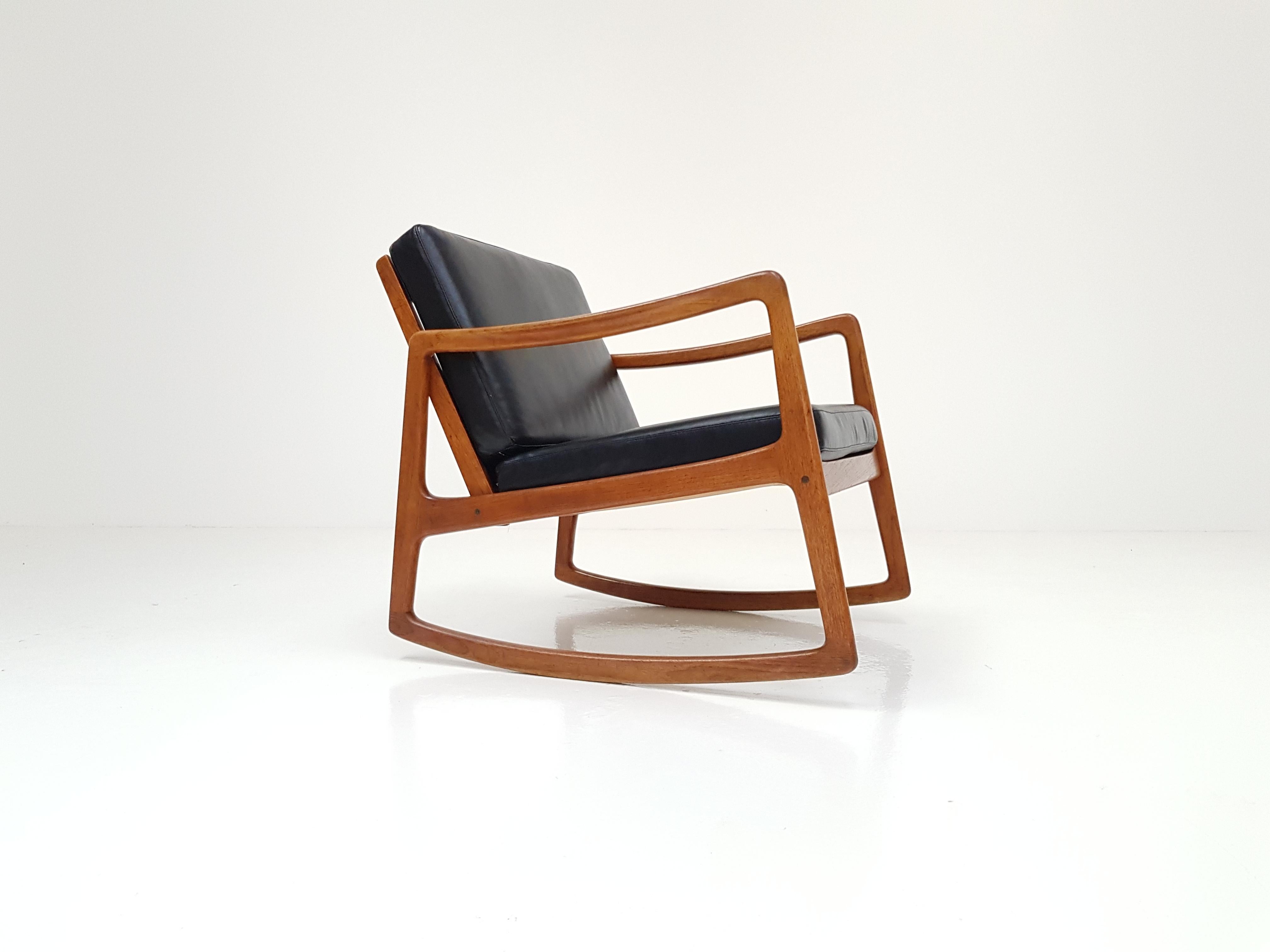 Ole Wanscher for France & Son model 120 teak rocking chair for France & Son in black aniline leather.

The receiver of a 'Good Design' award from MoMA New York. 

A rare Ole Wanscher design dating from 1952 with an amazing minimalist look,