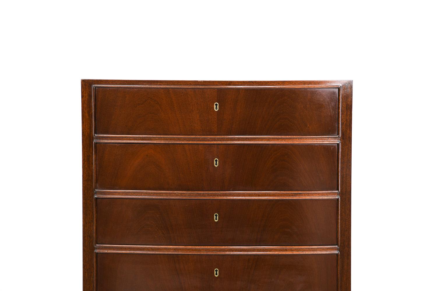 A mahogany chest of drawers with a slightly curved front and seven drawers with individual locks. Designed by Ole Wanscher and manufactured for retailer Illums Bolighus, Denmark, circa 1957.
 