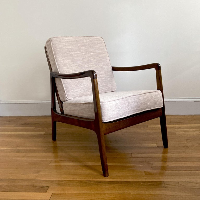 Gorgeous rare midcentury lounge chair, by Ole Wanscher for John Stuart; labeled on bottom of backrest. Walnut wood, newly reupholstered in blush tweed. Model FD-109, structurally sound and wood in good condition. 

Ole Wanscher (1903-1985) was