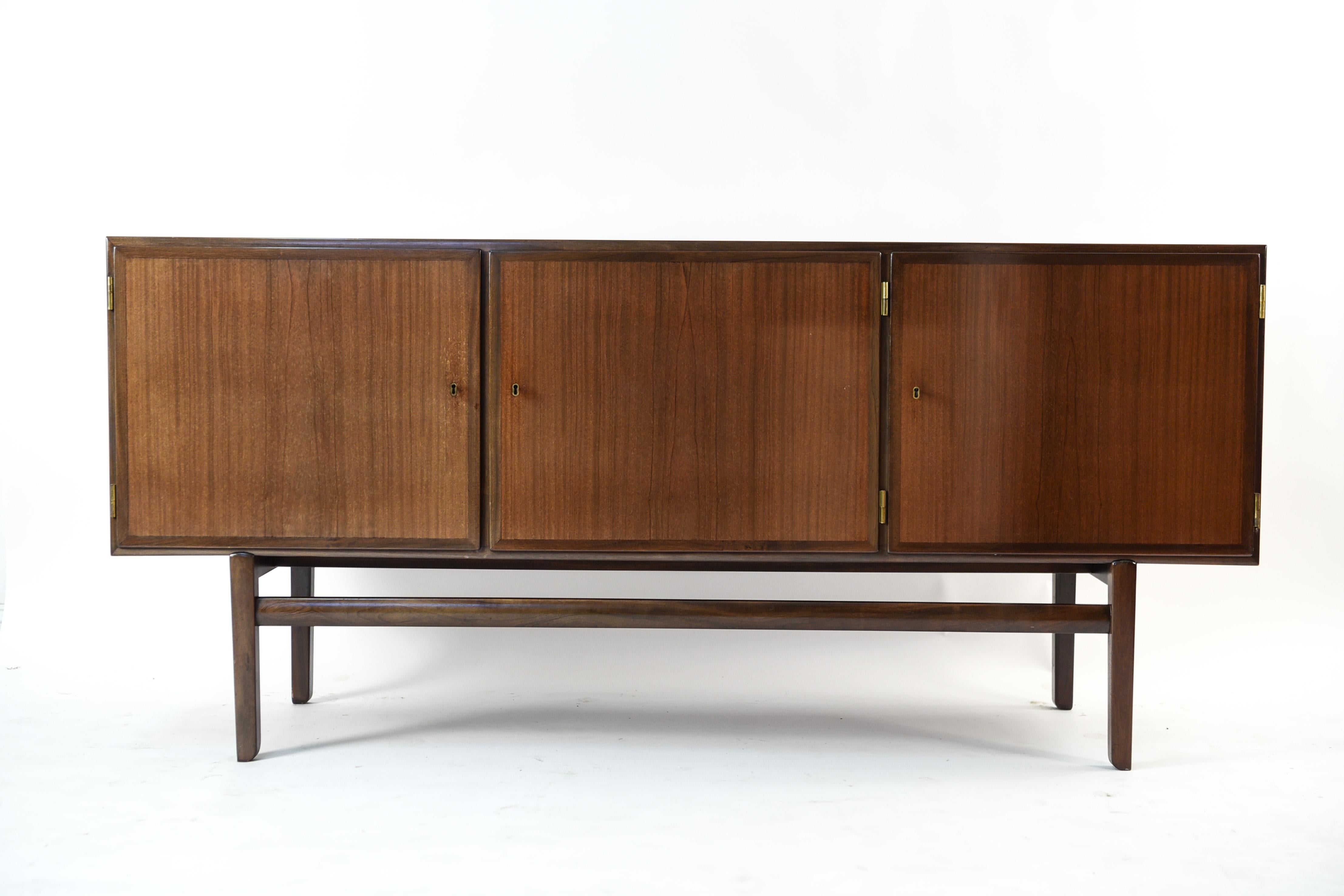 A gorgeous Danish midcentury mahogany Rungstedlund sideboard is part of a dining room set, and was designed for the dining room on Rungstedlund, named after author and adventurer Karen Blixens manor house in Rungsted, north of Copenhagen, called