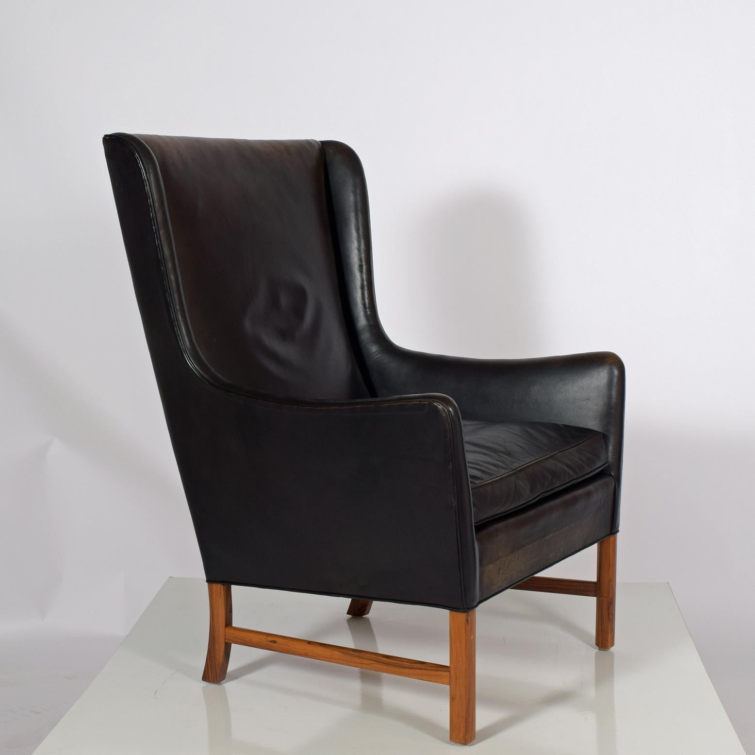 Black leather Brazilian rosewood, elegant armchair design by Ole Wanscher for A.J. Iversen original leather.