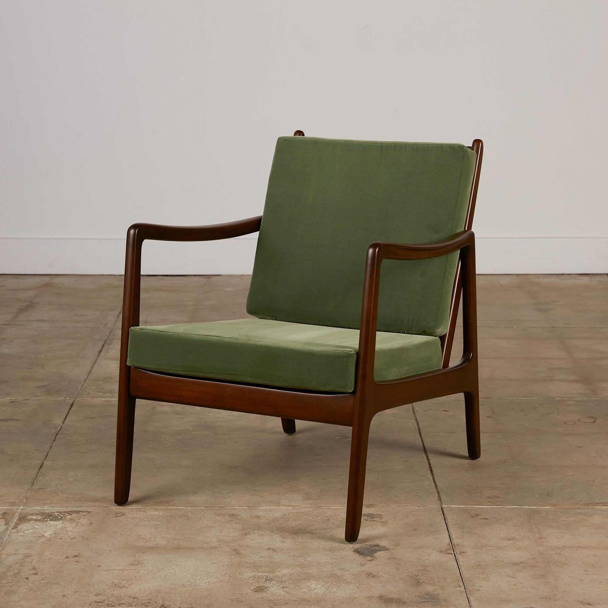 Danish modern “166” lounge chair by Ole Wanscher for France & Søn, circa 1951. The lounge chair features a sculpted teak frame and slatted teak back support with new green Italian cotton velvet cushions.

Ole Wanscher was a Danish furniture