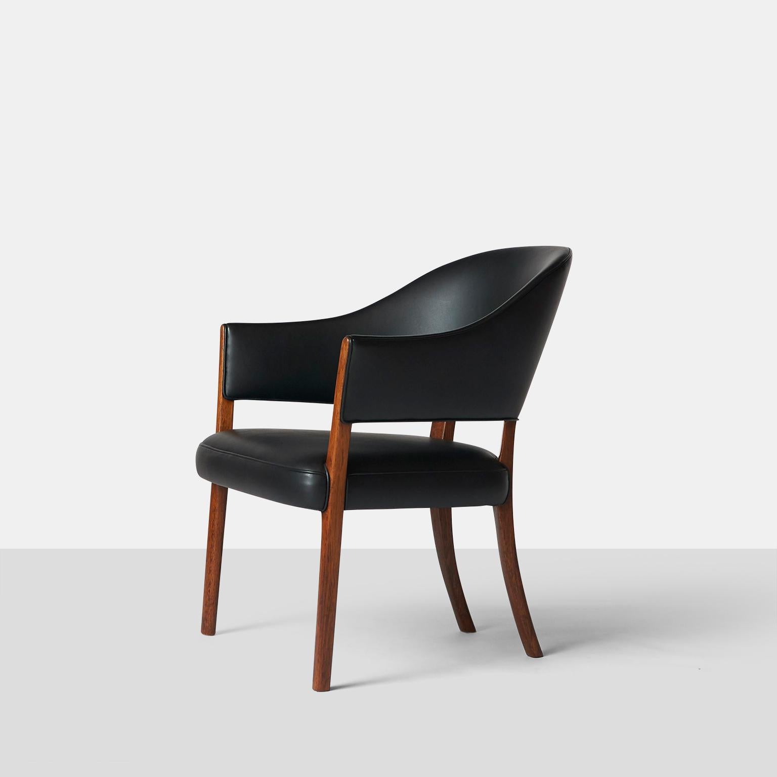 An easy chair with frame of rosewood. Seat and back upholstered with patinated black leather. Made by cabinetmaker A. J. Iversen, Copenhagen. The model was presented at the 1962 Copenhagen cabinetmakers guild's exhibition.

Refinished in black