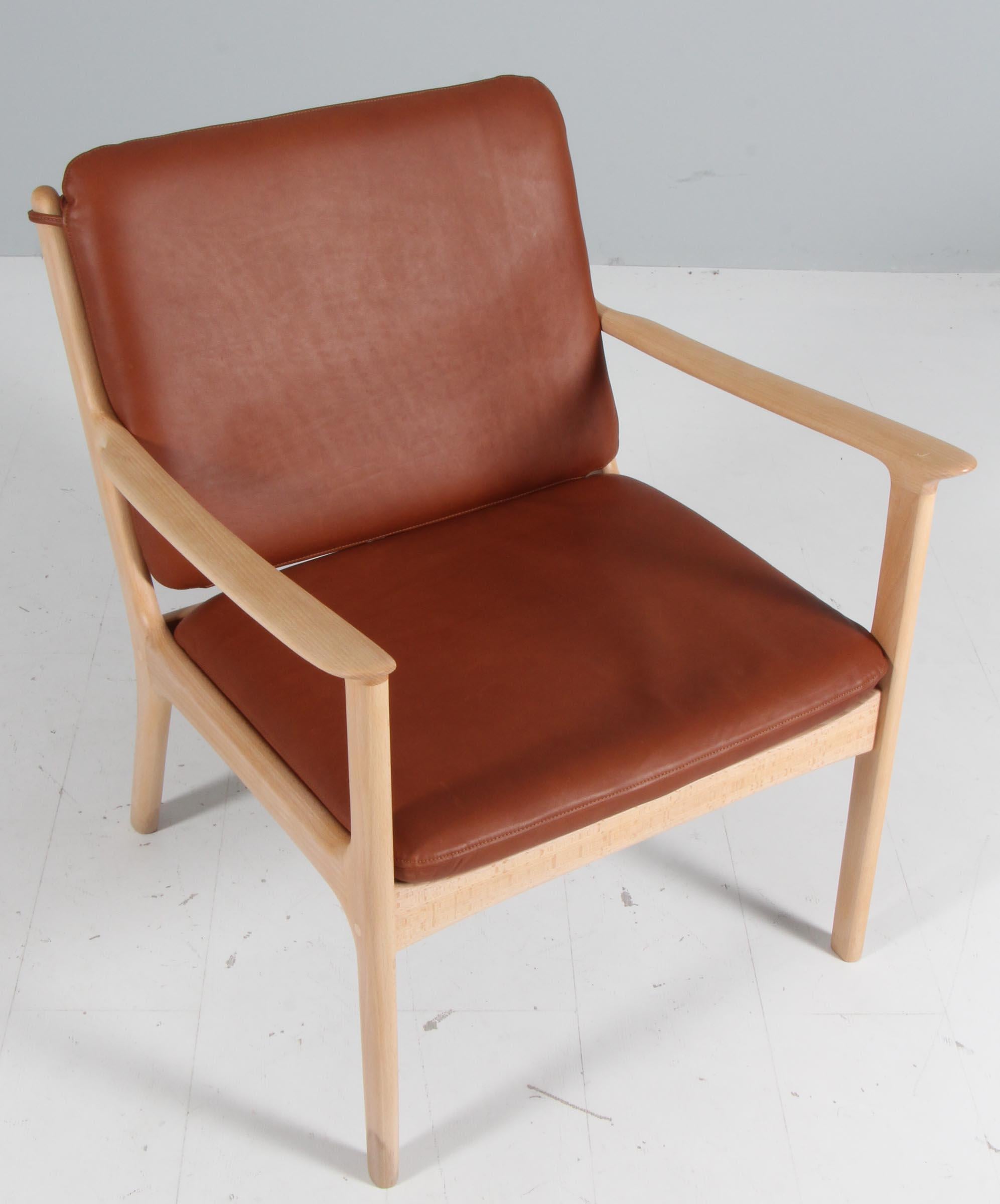 Ole Wanscher lounge chair new upholstered in brandy coloured aniline leather. 

Made of solid soap treated beech.

Model PJ 112, made by Poul Jeppesen.

 