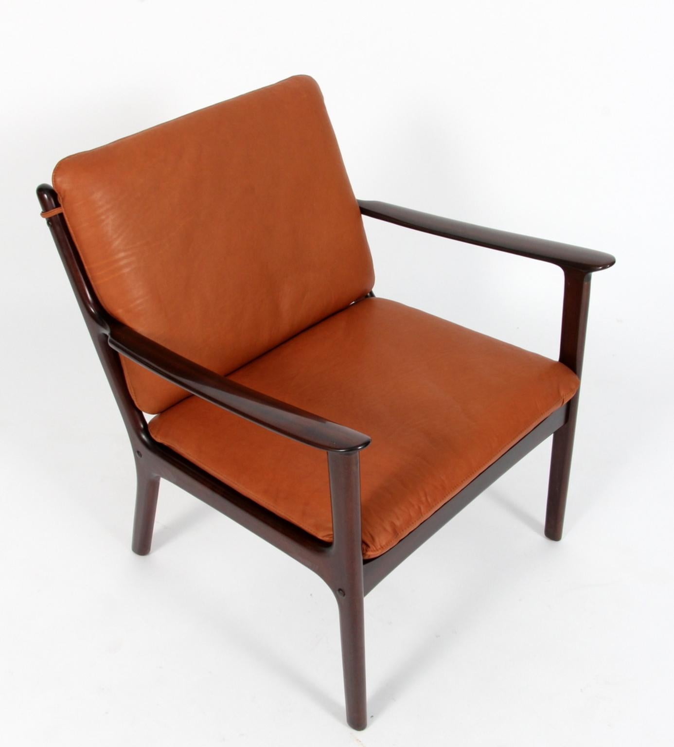 Ole Wanscher lounge chair new upholstered in cognac aniline leather. 

Made of massive mahogany.

Model PJ 112, made by Poul Jeppesen.

 