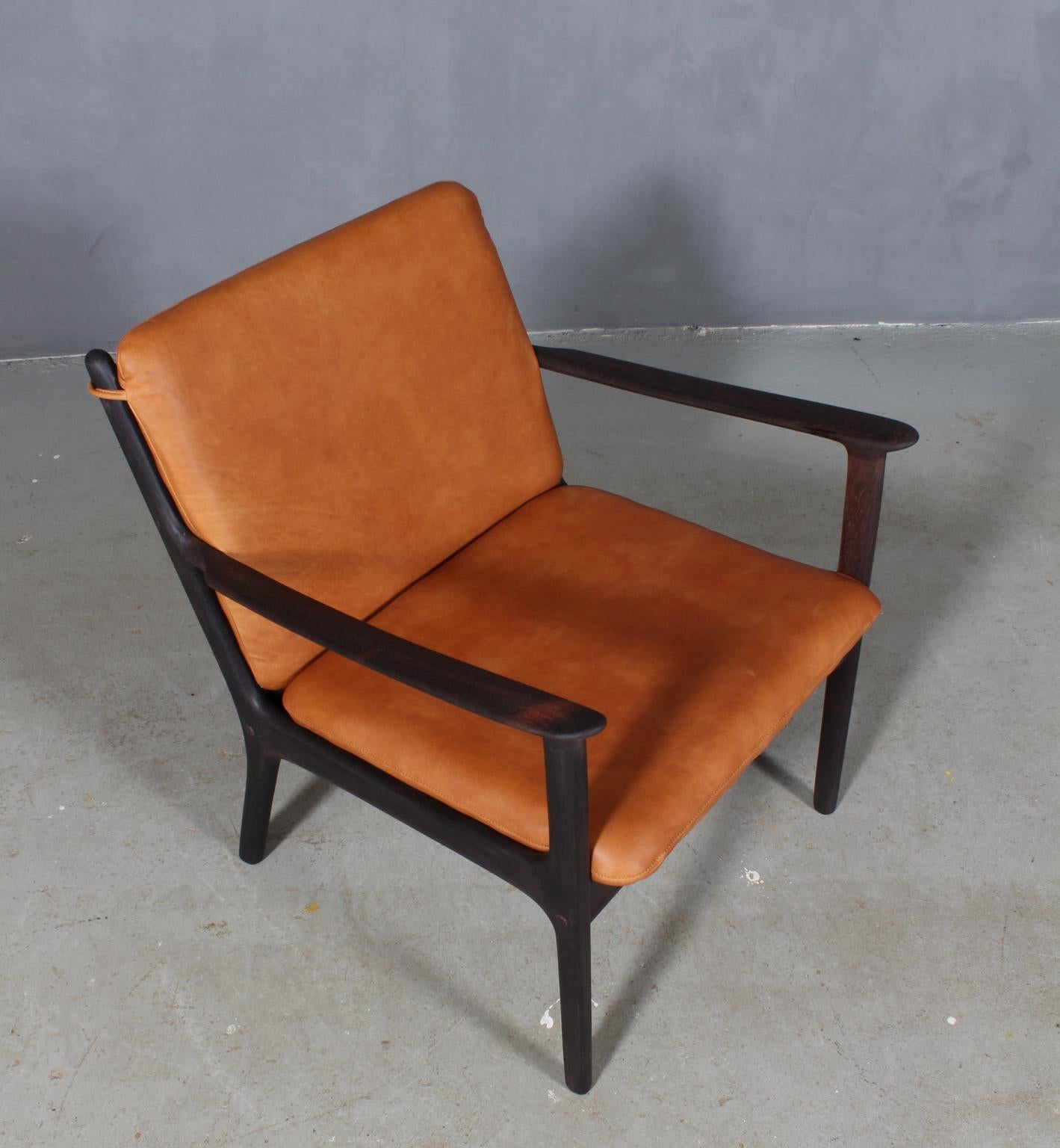 Ole Wanscher lounge chair new upholstered in tan Vintage aniline leather. 

Made of solid oiled rosewood.

Model PJ 112, made by Poul Jeppesen.

 