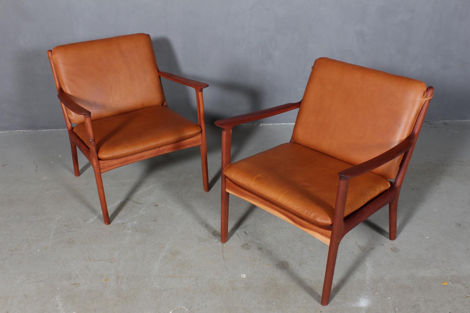 Ole Wanscher lounge chairs new upholstered in vintage cognac aniline leather. 

Made of massive oiled mahogany.

Model PJ 112, made by Poul Jeppesen.

   
