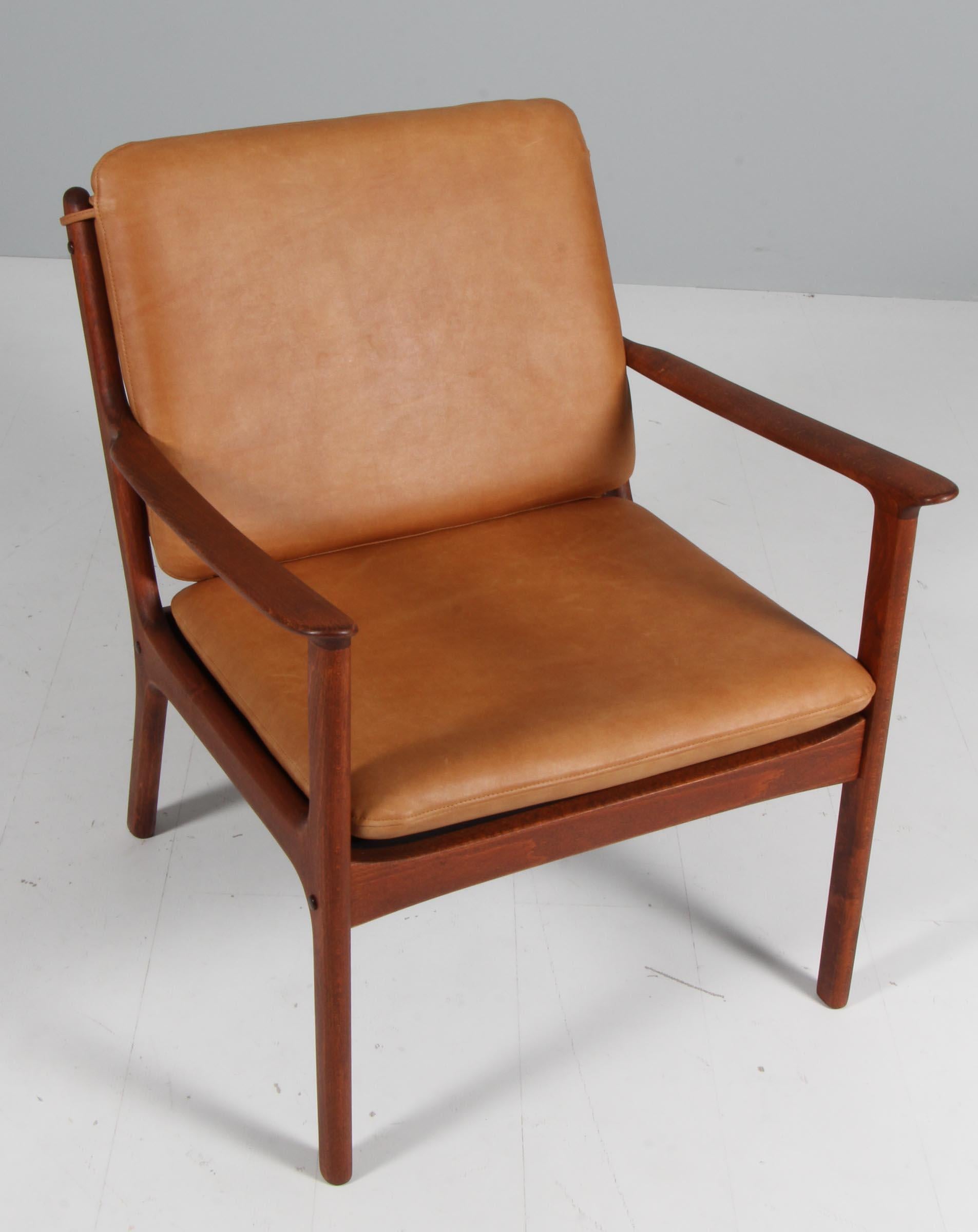 Chaise de salon Ole Wanscher nouvellement recouverte de cuir aniline cognac vintage. 

Fabriqué en hêtre massif teinté.

Modèle PJ 112, fabriqué par Poul Jeppesen.

