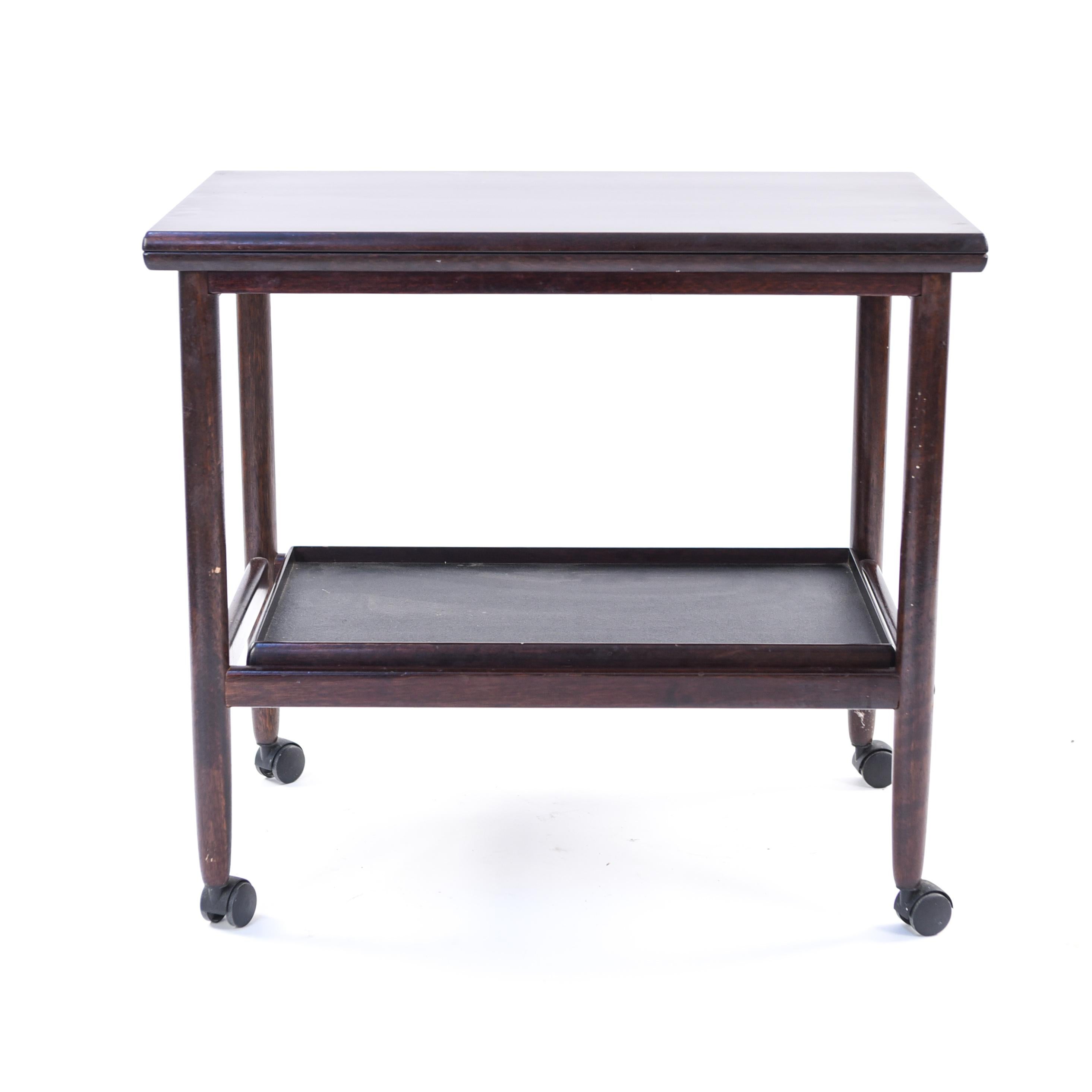 This mahogany serving cart was designed by Ole Wanscher for Poul Jeppesen's dining set 