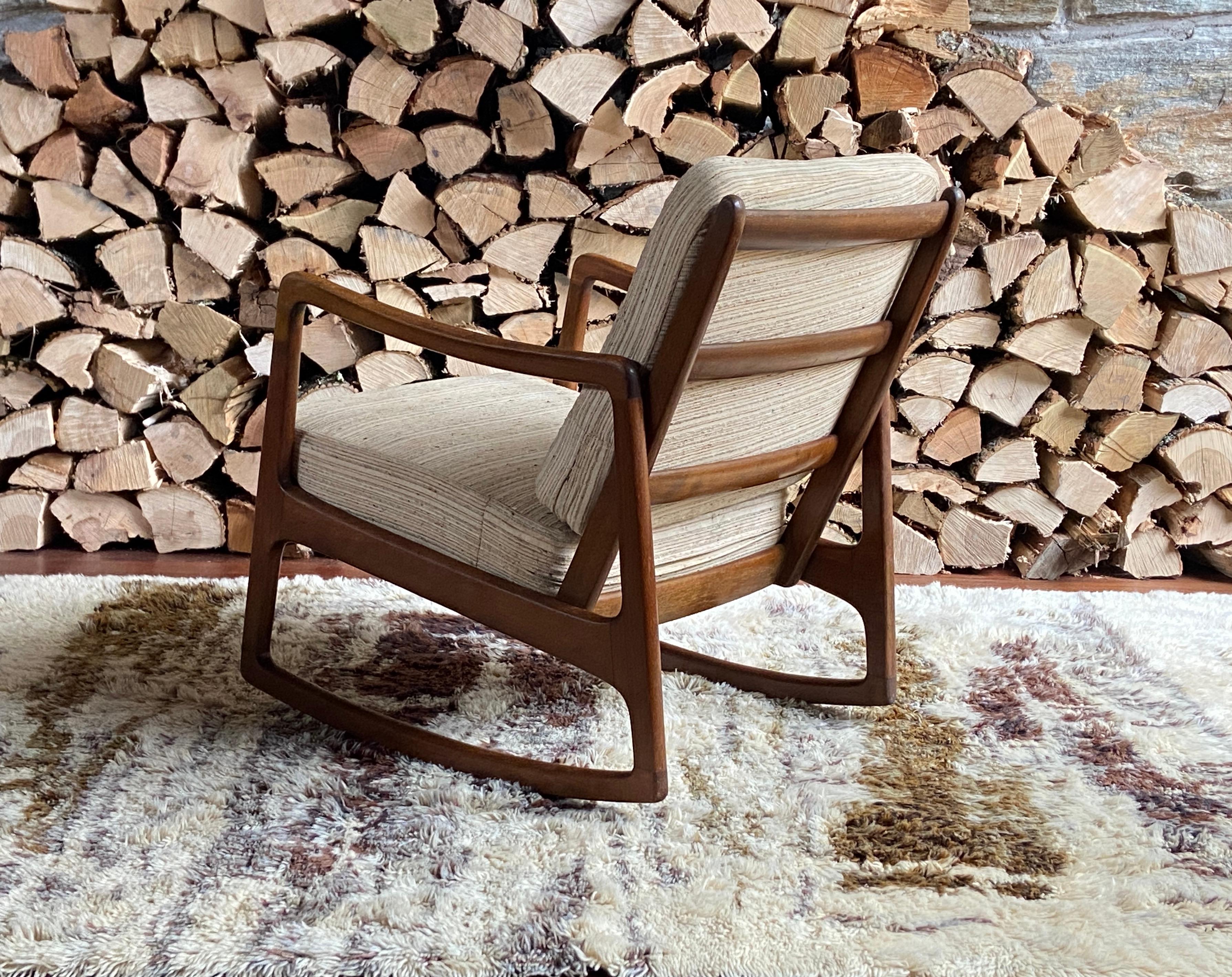 Beautiful mid century Danish teak model Fd-110 rocking chair by Ole Wanscher, made by France & Sons/John Stewart. The frame is in nice vintage condition - has been lightly restored - gone over with fine steel wool and a natural wood restorer, while