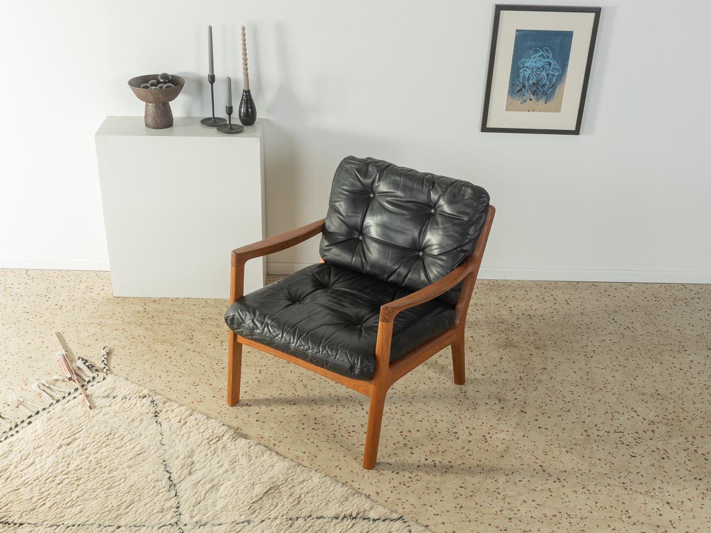 Classic armchair from the 1960s. Model Senator by Ole Wanscher for France & Søn. High-quality solid teak frame and cushions with original leather cover in black.

Quality Features:
 Accomplished design: perfect proportions & visible attention to