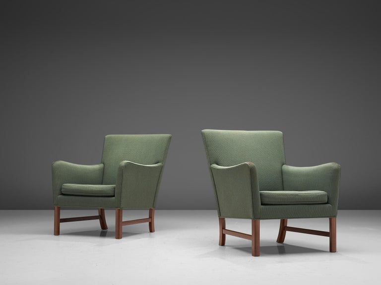 Ole Wanscher for A.J. Iversen, pair of armchairs, mahogany and soft green fabric, Denmark, 1950s. 

This pair of lounge chairs is designed by Ole Wanscher for A.J. Iversen in the 1950s. Typical Danish design traits are shown, such as exquisite