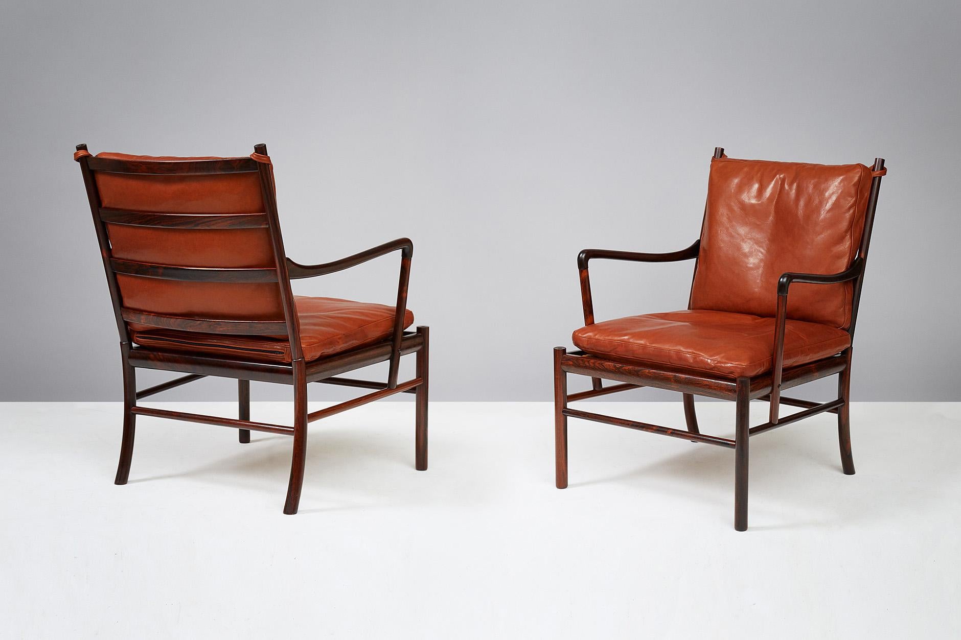 Ole Wanscher

PJ-149 Colonial chairs, 1949.

These examples made from Brazilian rosewood with woven rattan cane seats. Produced by Poul Jeppesen, Denmark, circa 1950s. Cognac brown aniline leather seat cushions with loose feather filling.