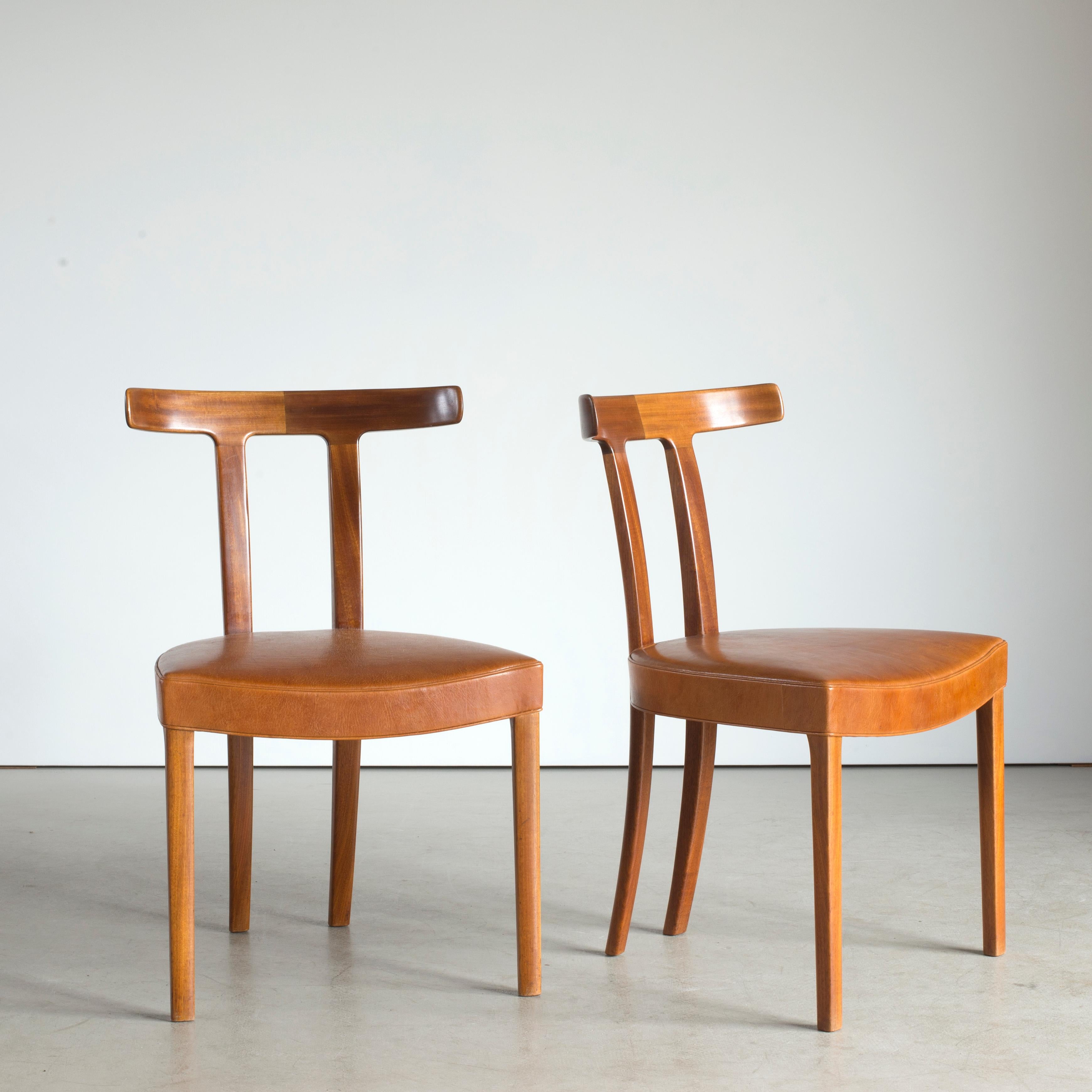 Ole Wanscher pair of 'T' chairs of mahogany. Executed by cabinetmaker A.J. Iversen, Denmark.

Underside of each chair with manufacturer's paper label Snedkermester A.J. Iversen Kóbenhavn.