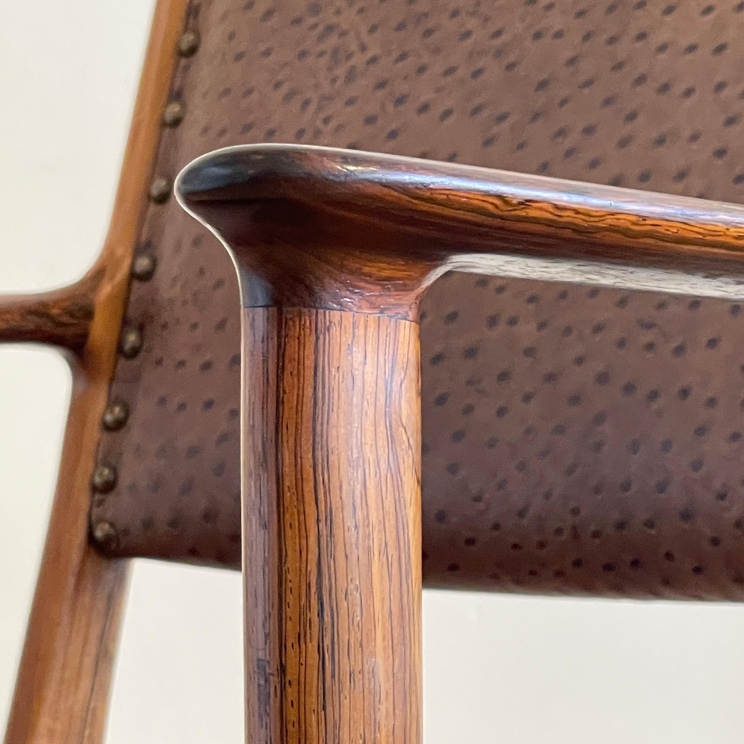 Rare set of 6 Ole Wanscher wide arm chairs in rosewood. Resone in a glorious ostrich embossed chocolate brown genuine leather with lovely brass tack detailing. 
These make great occasional chairs as they are so sculptural and independent. They are