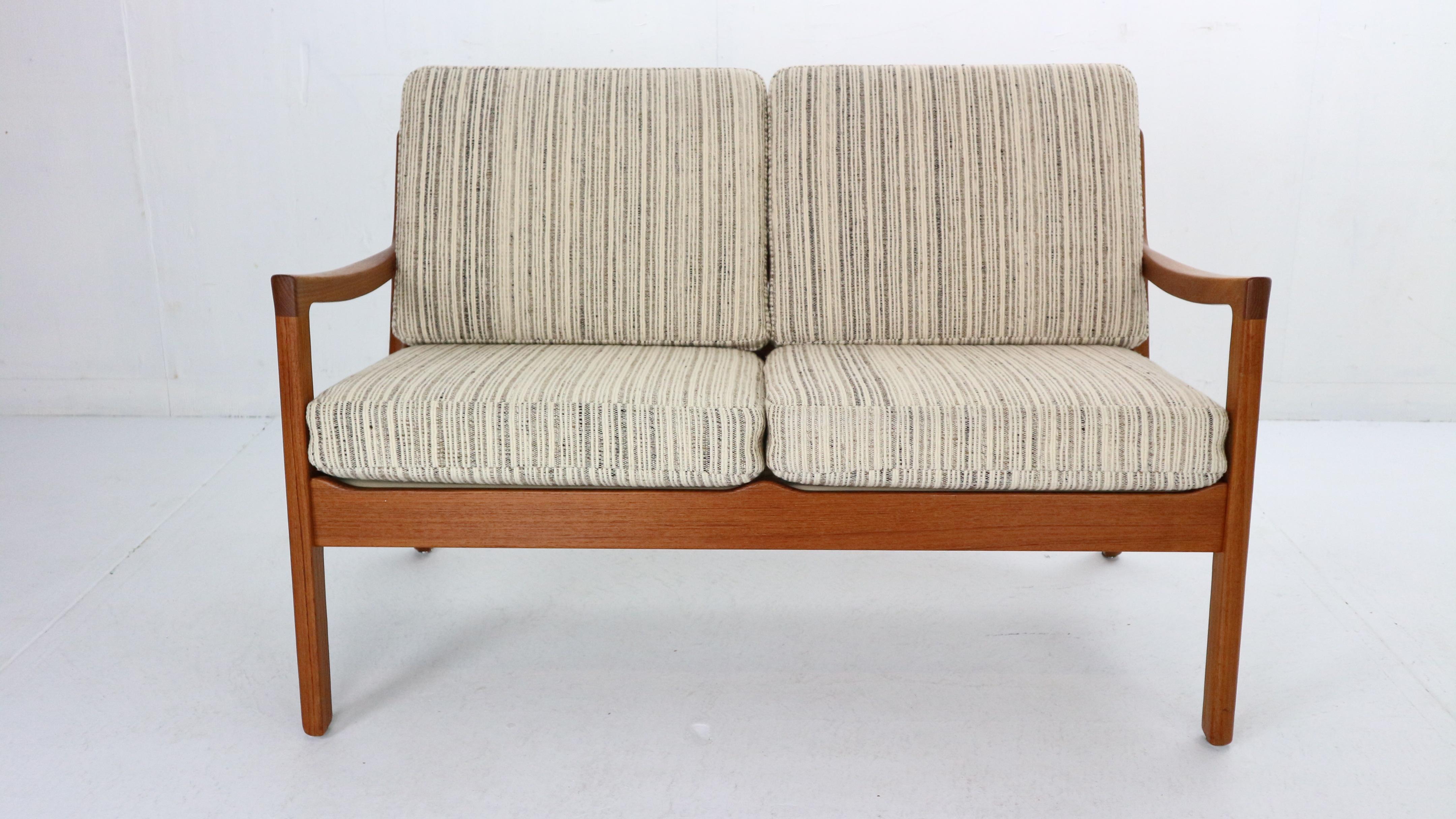 Two seater sofa designed by Ole Wanscher for France & Søn in Denmark, 1960's.
Model ’Senator 166’, originally marked on the frame.
This Senator series maintains features a study teak wood frame with a slated open back and angled and curved legs &